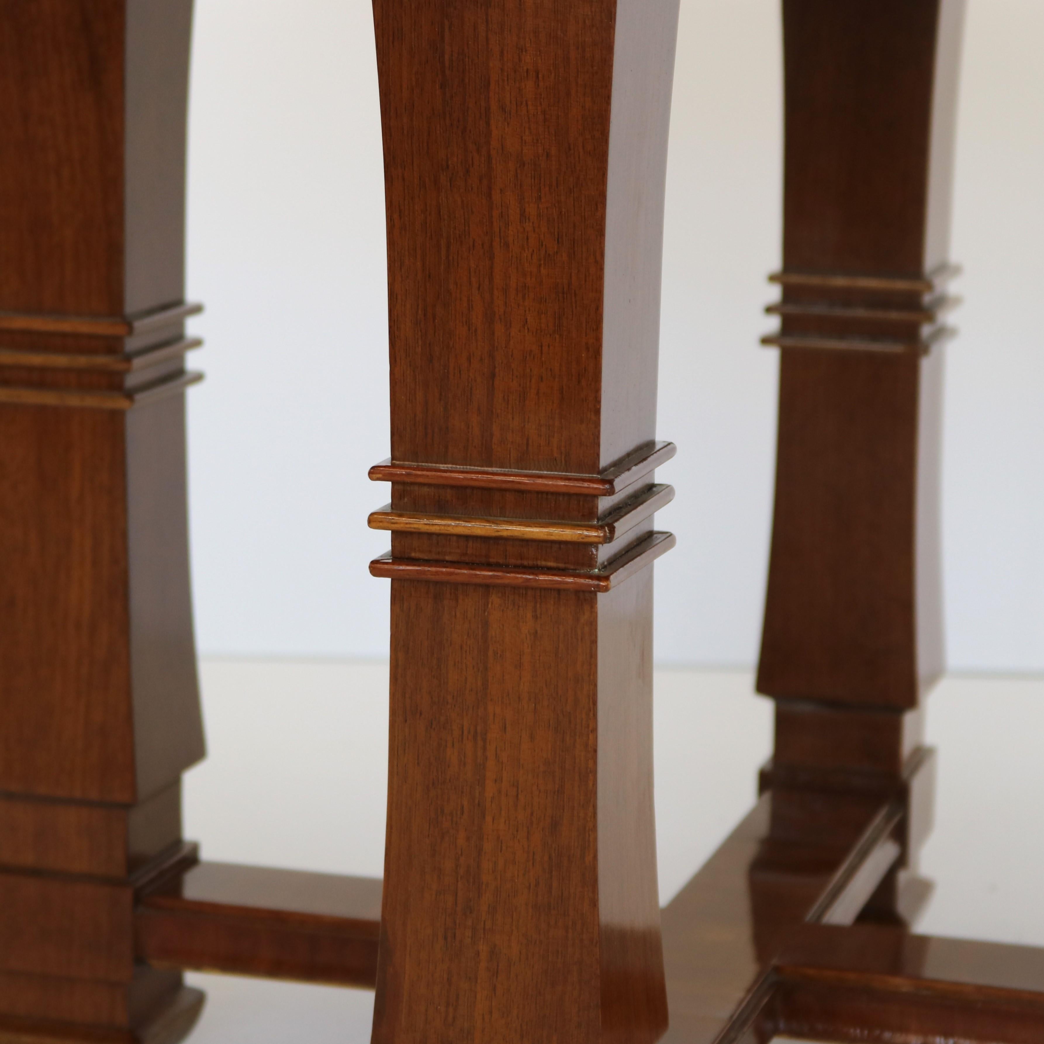 Modernist side table from France circa 1940. The circular top is veneered in spectacular wood to create a starburst pattern. All four legs possess the unique shape of a taper and inverted taper joined by a ring of three horizontal bands. The legs