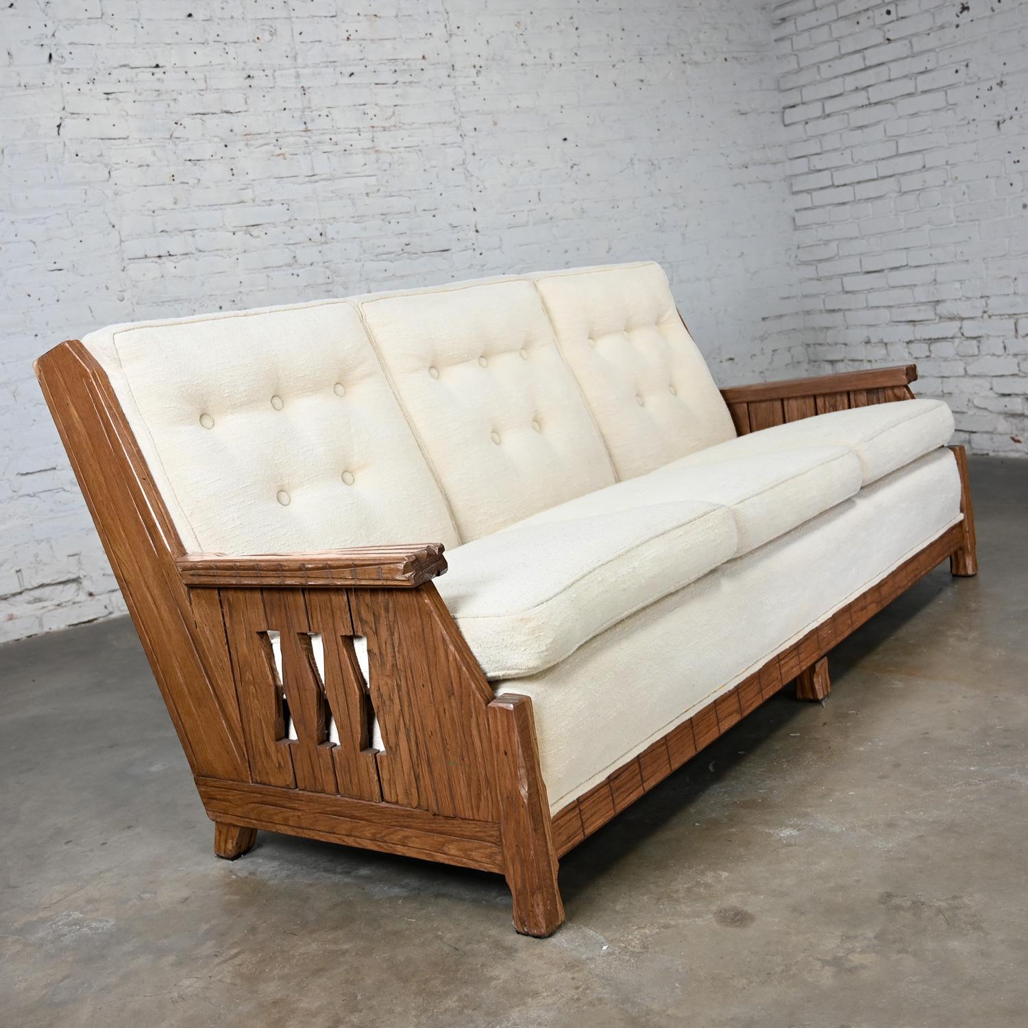 Gorgeous vintage rustic or Western style sofa attributed to A. Brandt Ranch Oak comprised of a medium or honey toned Ranch Oak finished frame & reupholstered in a white vanilla toned nubby linen-like fabric with button detail on the back cushions.
