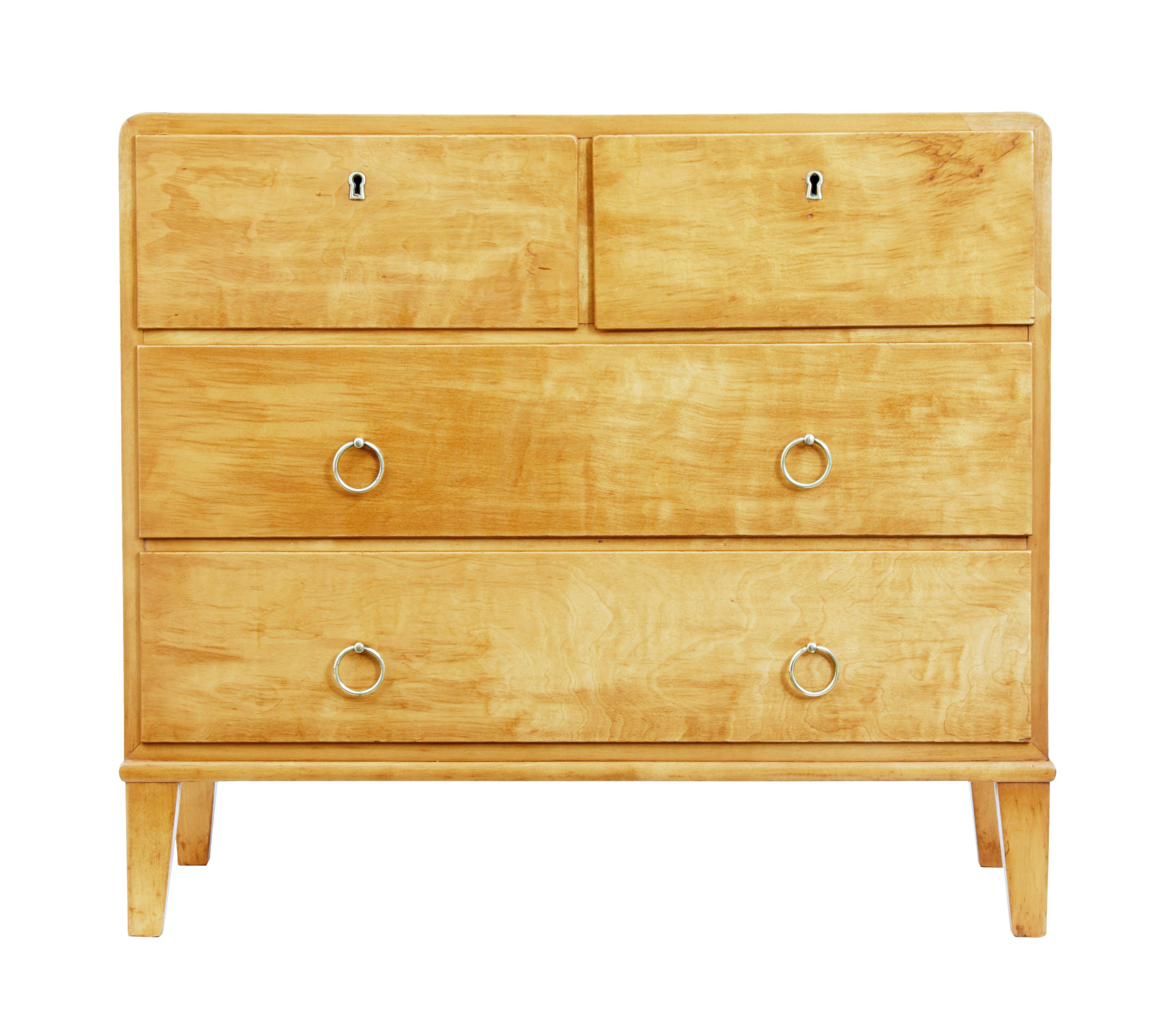 Mid-20th century Scandinavian birch chest of drawers, circa 1950.

Stylish chest of drawers of small proportions, rounded top edges in the Art Deco taste, 2 short drawers over 2 long. Top 2 drawers open on the key, bottom drawers with brass ring