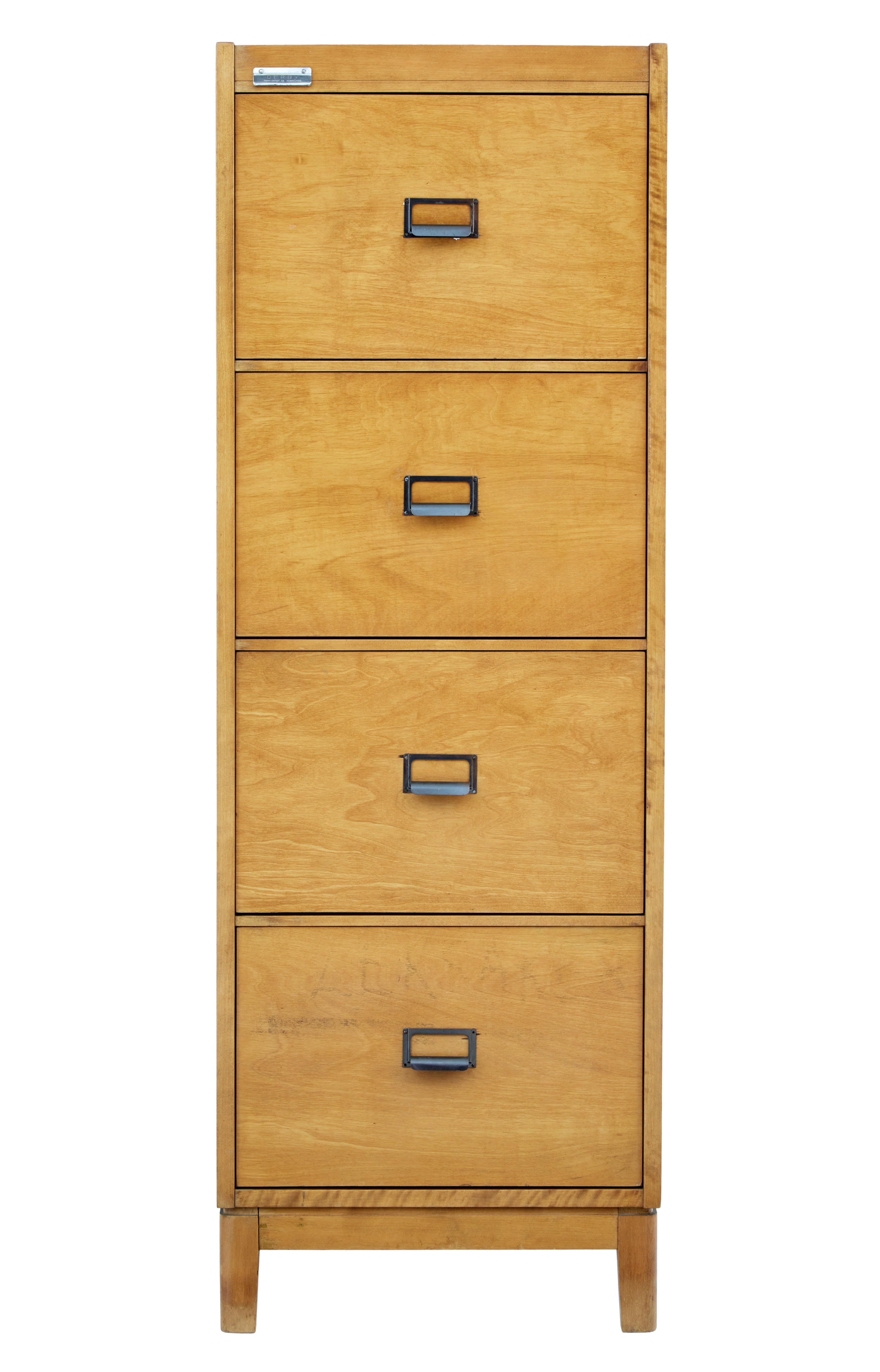 Fine piece of functional office furniture with the Scandinavian touch, circa 1950.

4 deep standard file size drawers, with metal handle and label attachment. Side with contrasting darker birch veneered sides.

Minor surface marks, 1 very small