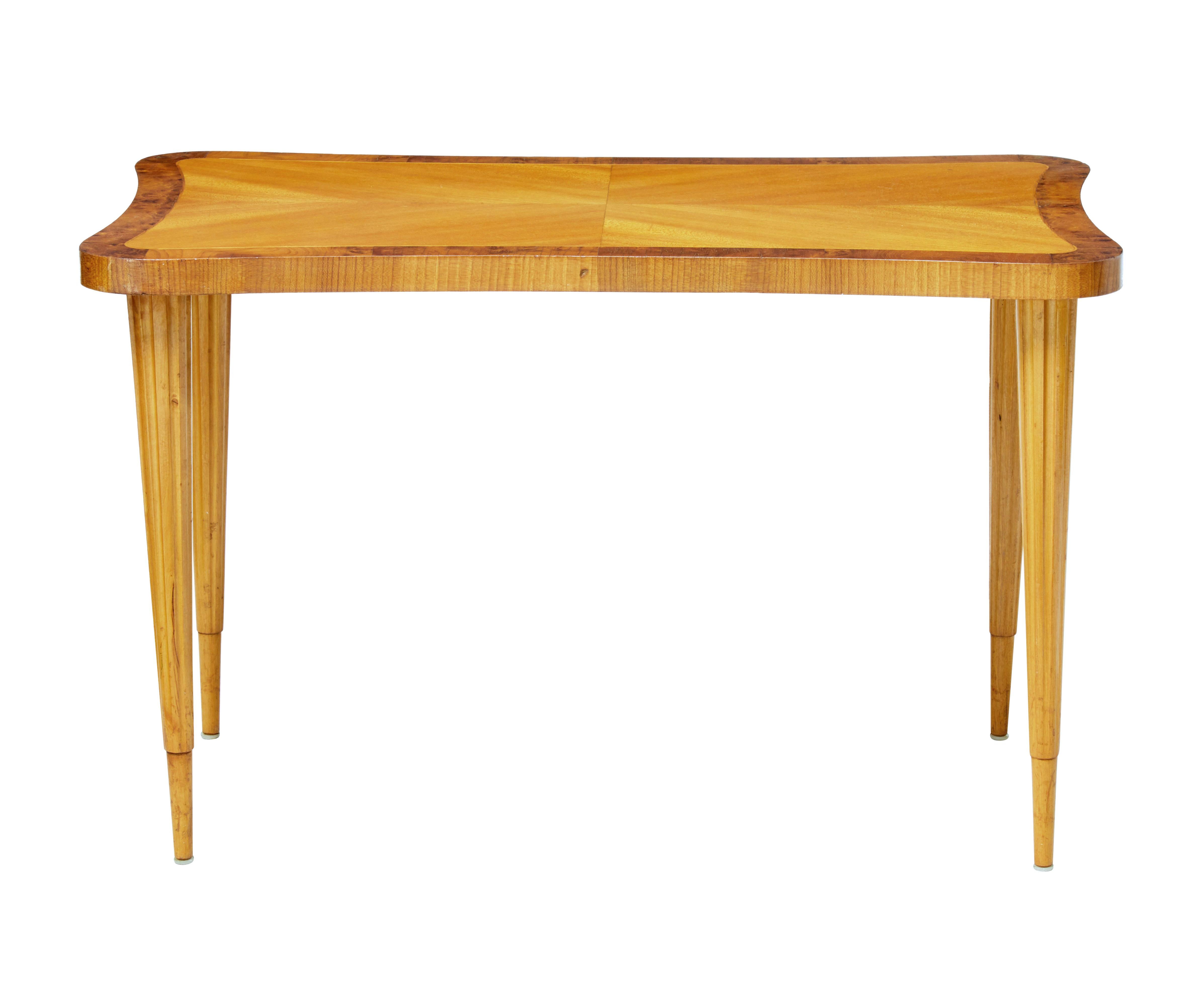 Mid-20th century Scandinavian birch shaped coffee table, circa 1950.

Unusual concave shaped sides. Quarter veneer birch top with bur walnut around the outer edge.

Standing on 4 fluted tapering legs.

Minor surface marks.