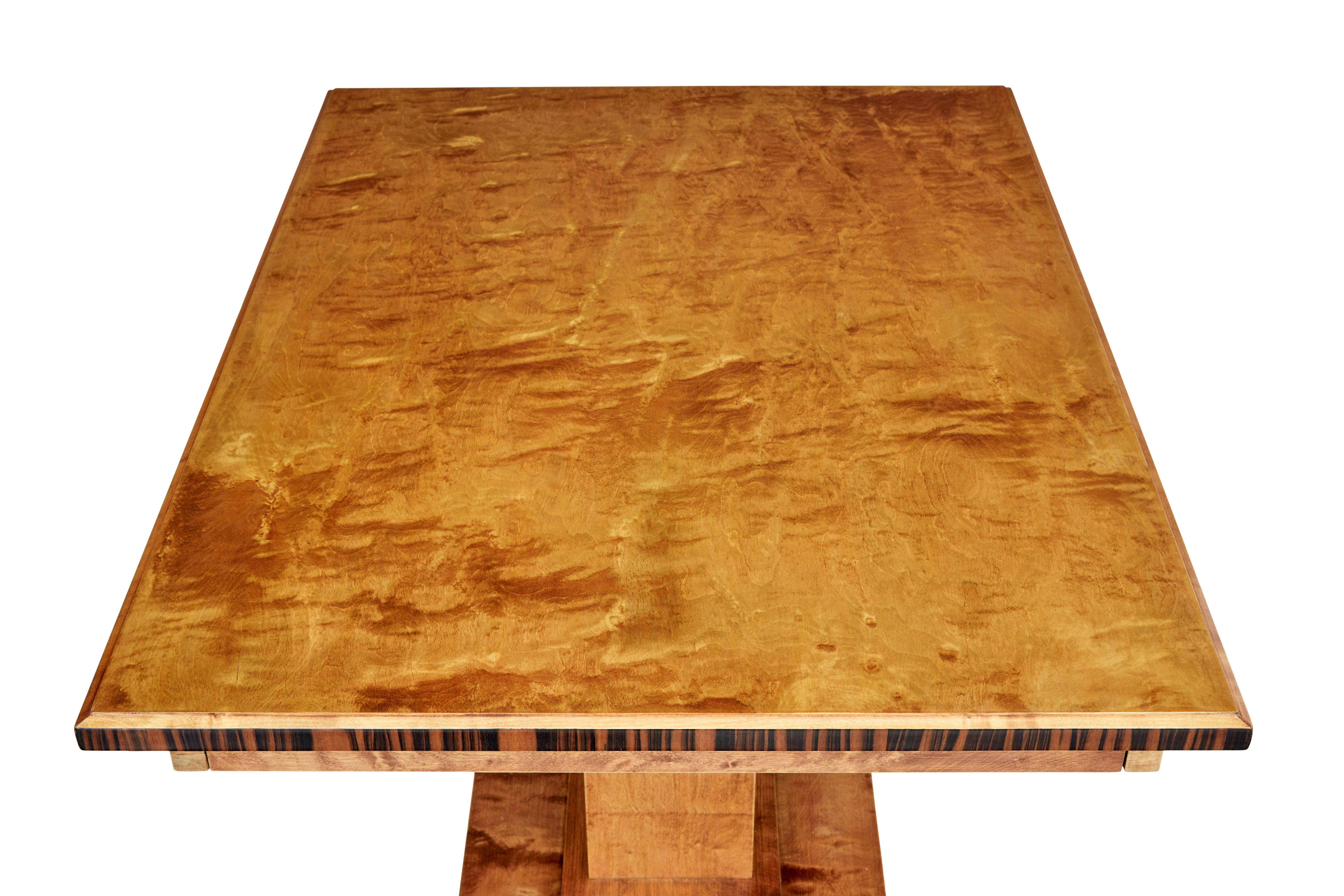 Mid 20th century Scandinavian birch side table circa 1940.

Rectangular top side or sofa table made in birch.  Oversailing top decorated with kingwood veneer.  Supported by a central pedestal with further kingwood detailing.  Standing on a platform