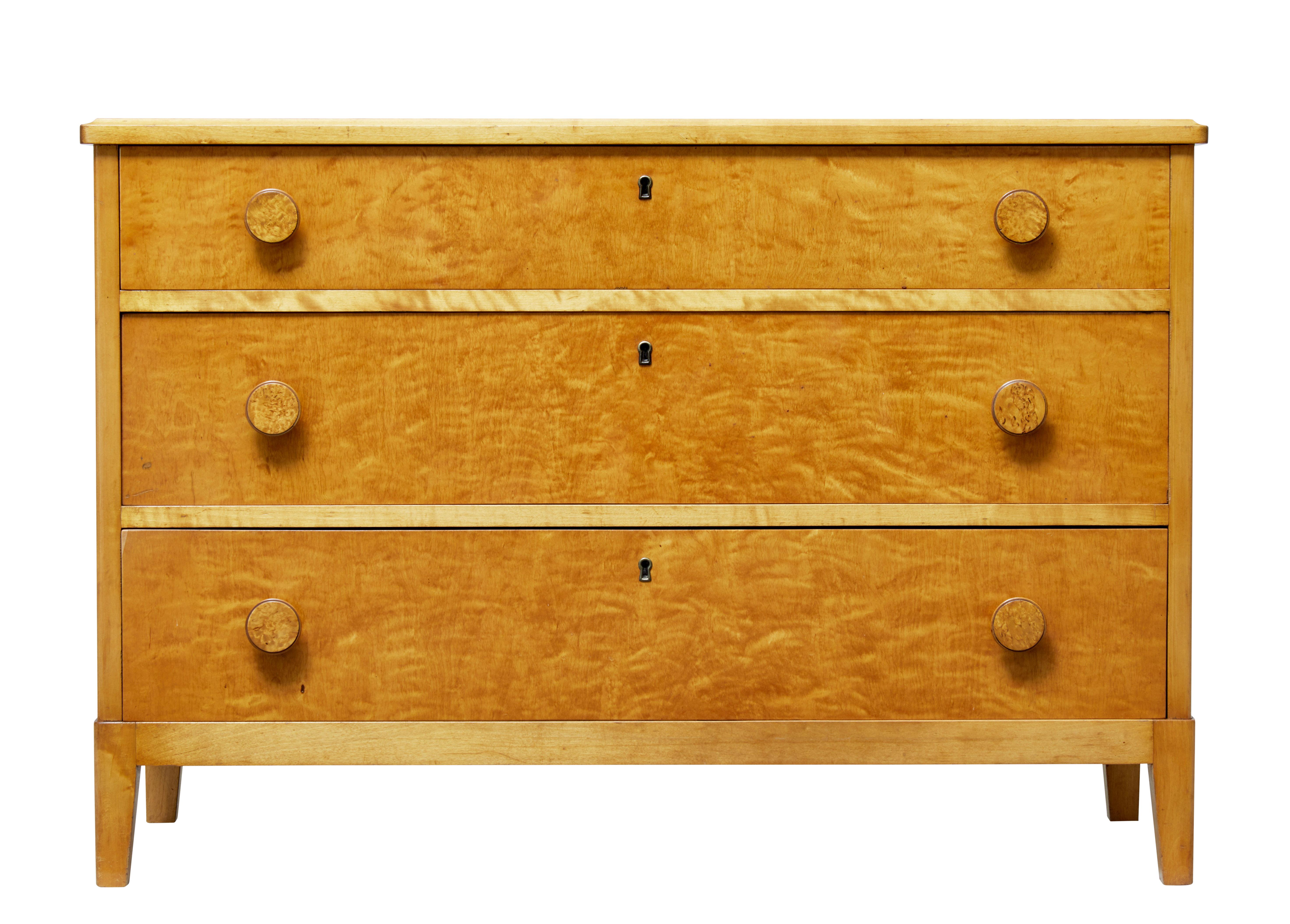 Good quality Swedish chest of drawers, circa 1950.

Fitted with three graduating drawers and burr round knobs.

Rich birch color with fine veneers used. Standing on tapered legs.

Minor surface marks.