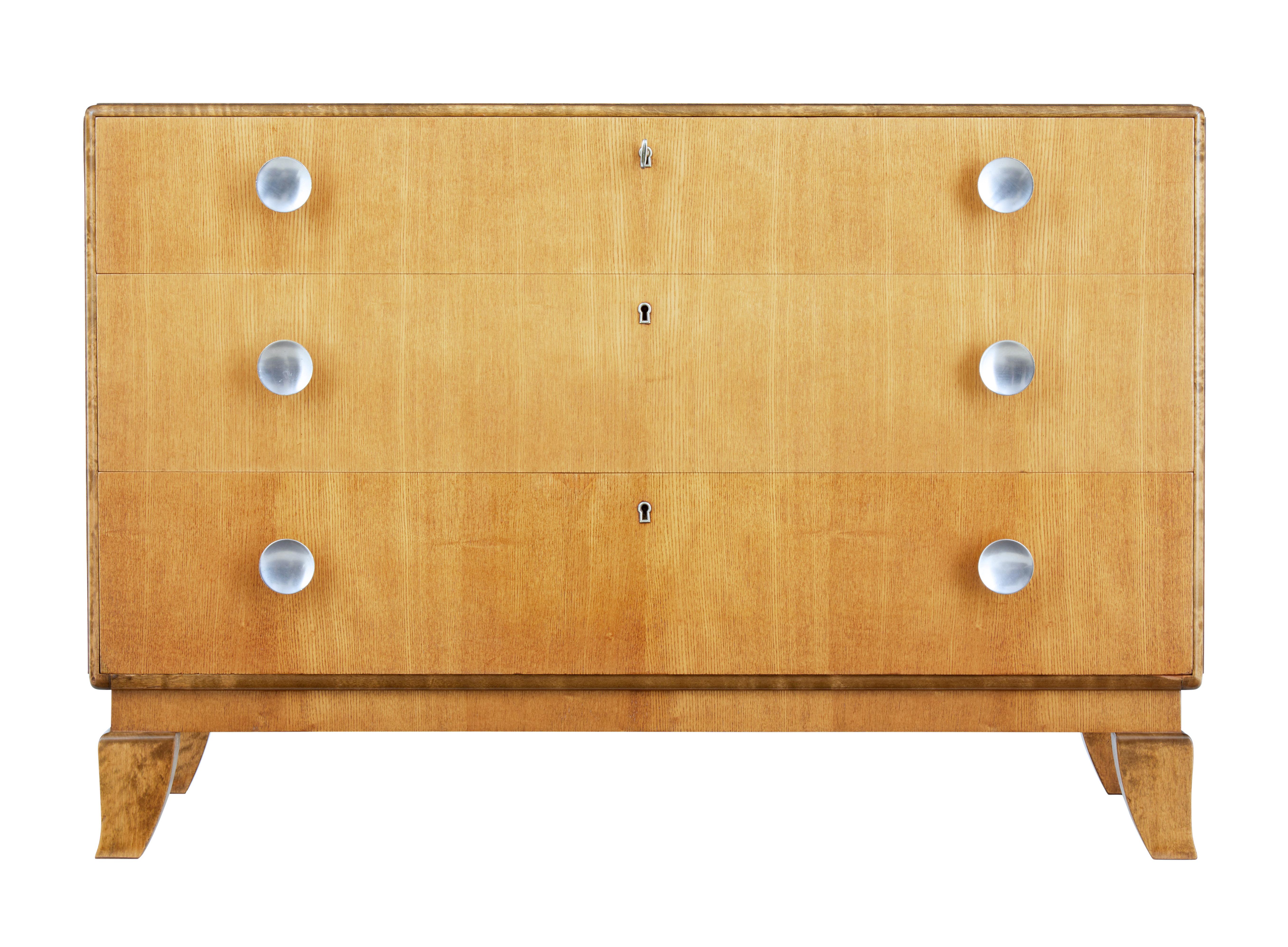 Mid-20th century Scandinavian elm and birch chest of drawers, circa 1950.

Very stylish piece of Scandinavian design. Dark birch outer frame which contrasts with elm.

3 graduating drawers with key and locks, brushed steel handles, standing on
