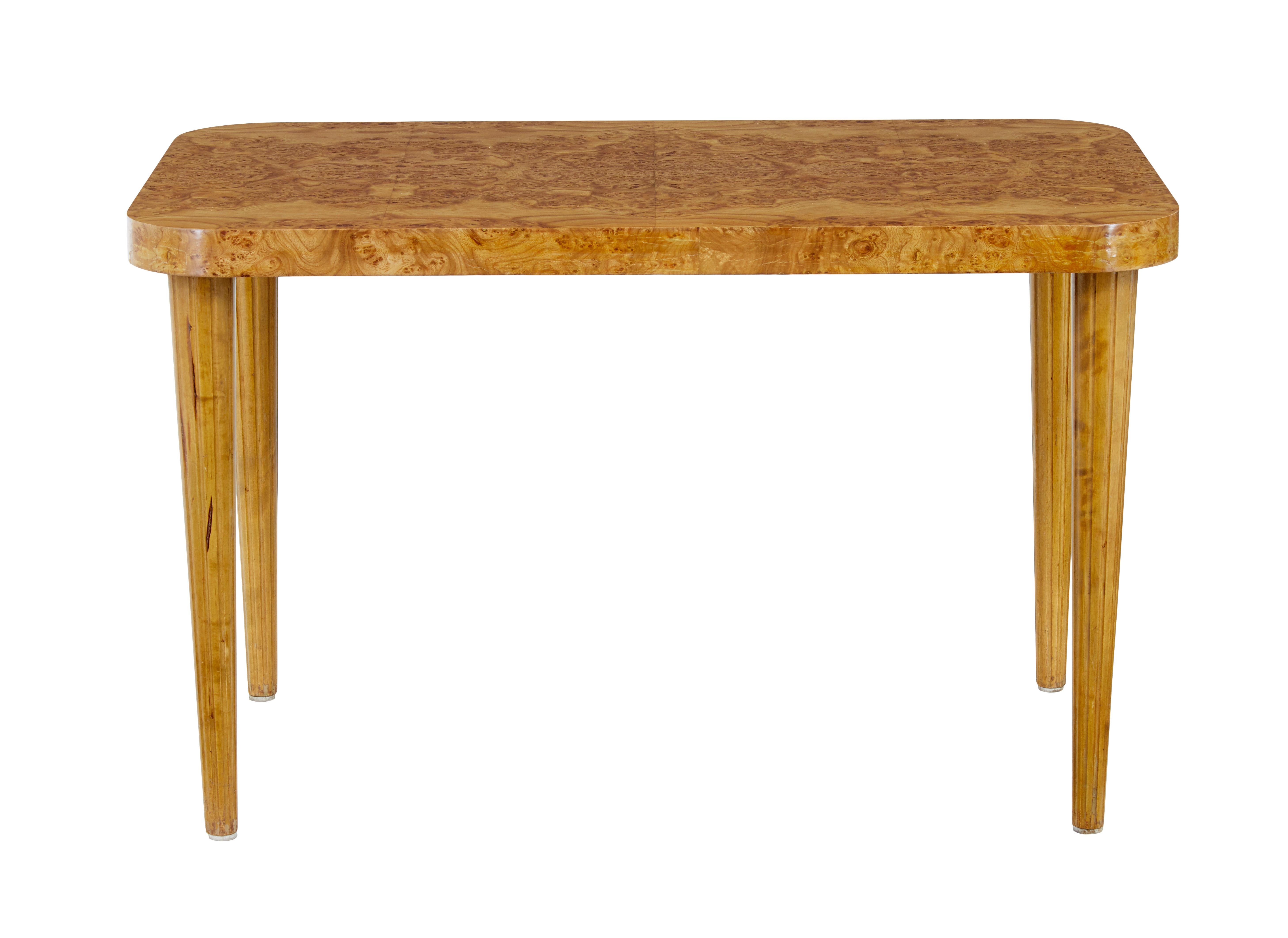 Mid 20th century Scandinavian elm root coffee table circa 1950.

Made using stunning matched elm root veneer.   Rectangular top with rounded edges with further veneer around the apron edge.

Supported by 4 birch tapering legs, with fluted detail. 