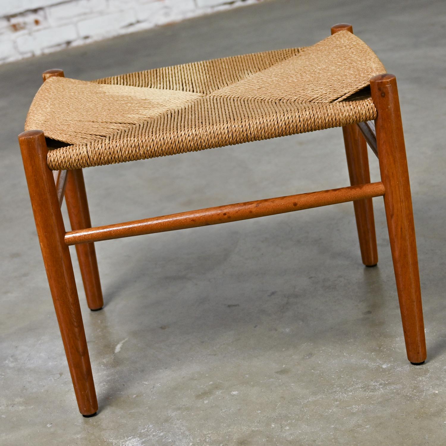 Fabulous Mid-20th Century Scandinavian Modern low stool comprised of a teak frame with a natural paper cord woven top. Beautiful condition, keeping in mind that this is vintage and not new so will have signs of use and wear. There is a bleach spot