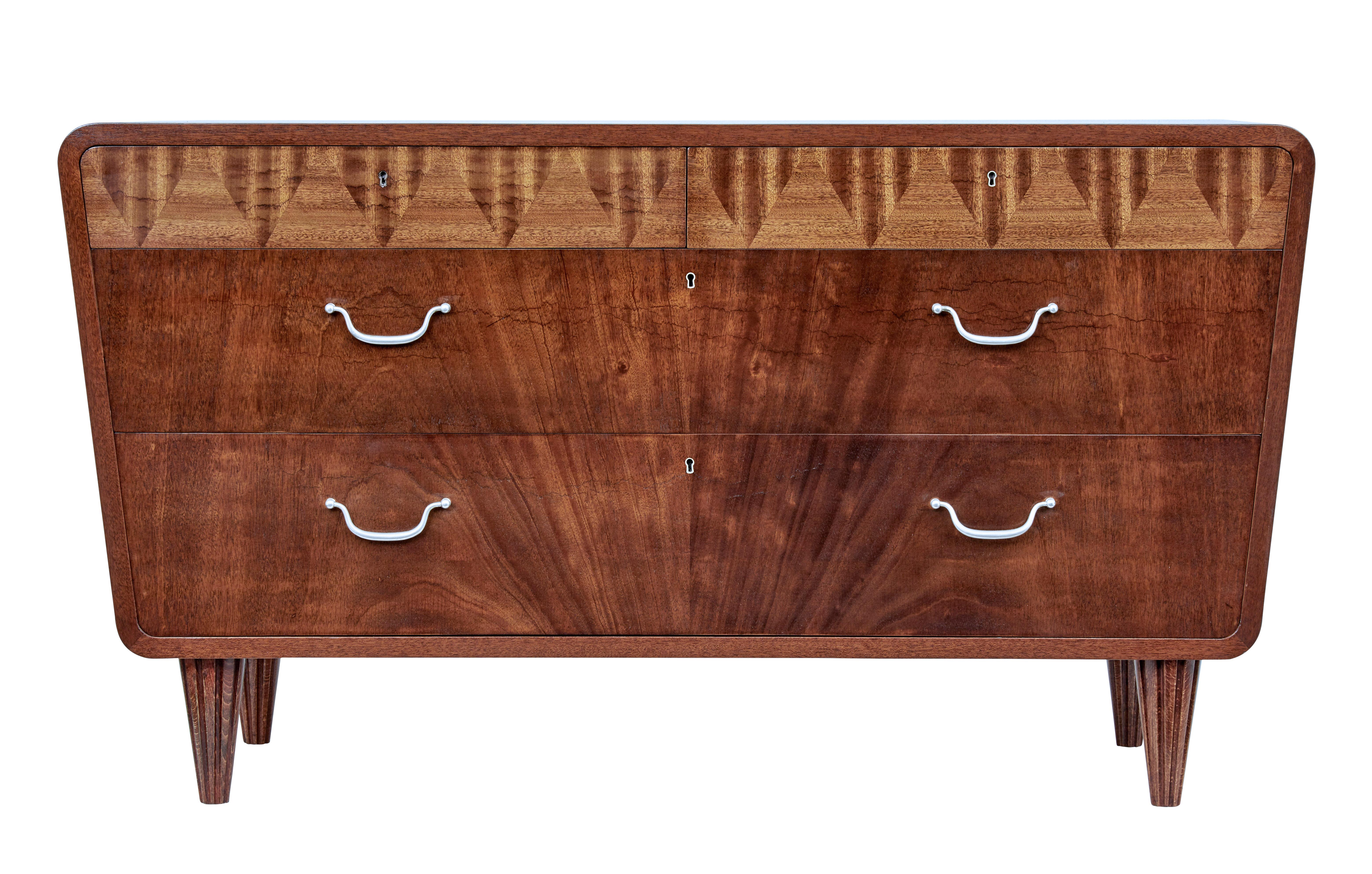 Mid-20th century Scandinavian Modern mahogany chest of drawers, circa 1950.

Stunning shaped chest of drawers very much in the Art Deco taste. 2 drawers below the top with a further 2 drawers below.

Top drawers with patterned veneer which open