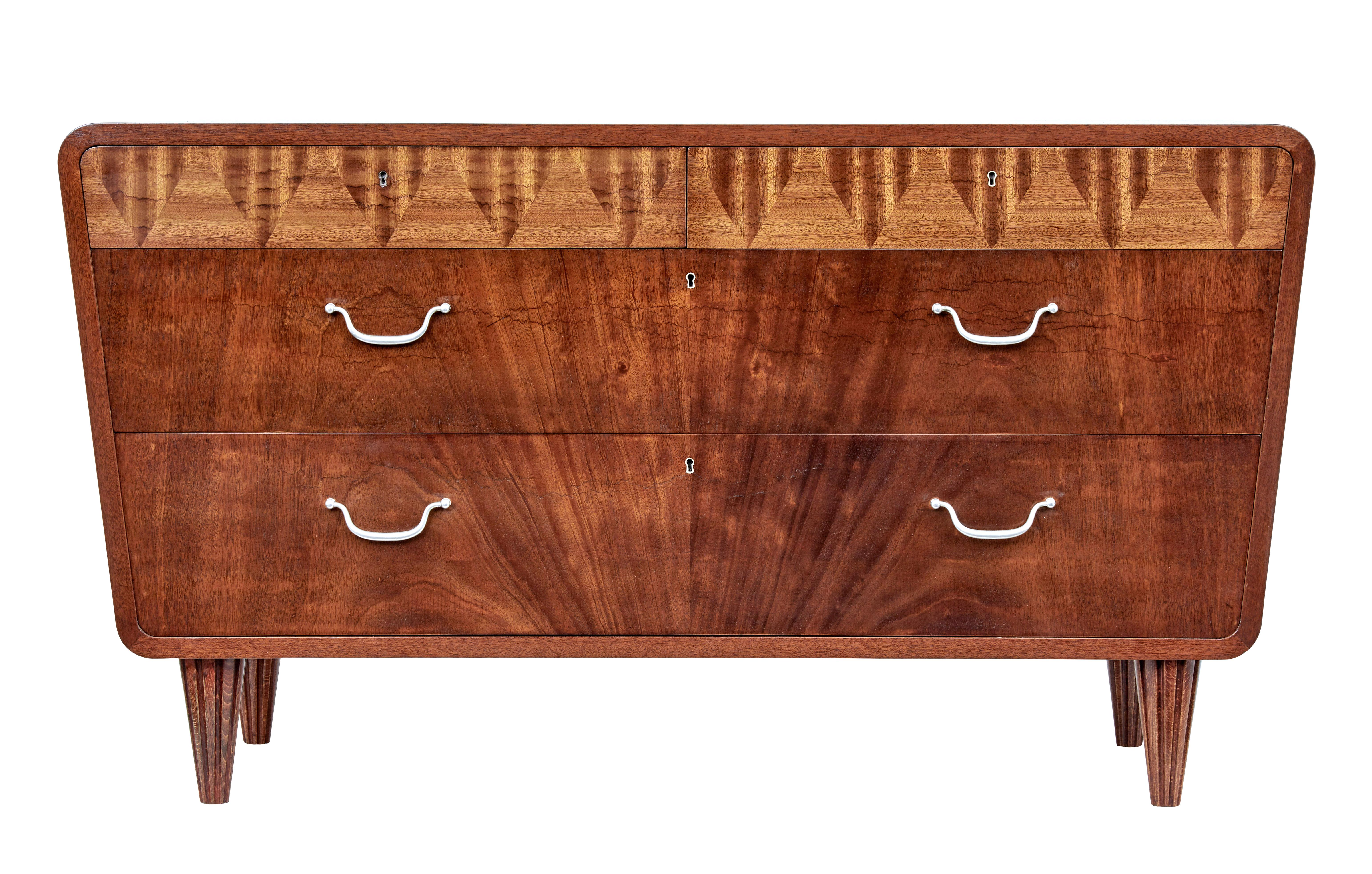 Mid 20th century Scandinavian modern mahogany chest of drawers circa 1950.

Stunning shaped chest of drawers very much in the art deco taste.  2 drawers below the top with a further 2 drawers below.

Top drawers with patterned veneer which open on