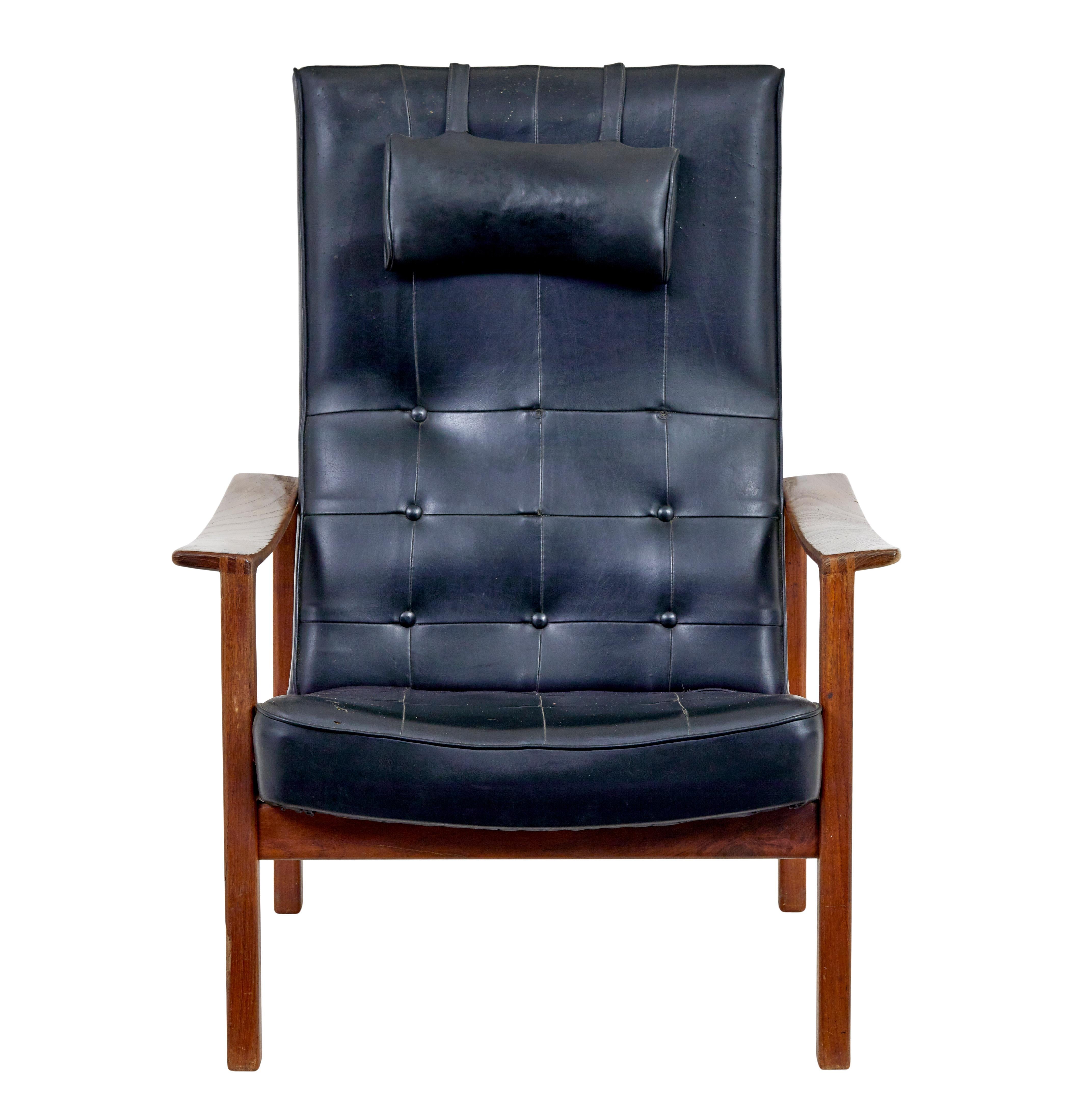 Mid 20th century Scandinavian modern teak reclining leather armchair circa 1960.

Solid teak show frame with a easy reclining action.  Elegant piece of Scandinavian mid century design.

Black leather with squared piping. A few buttons missing to the