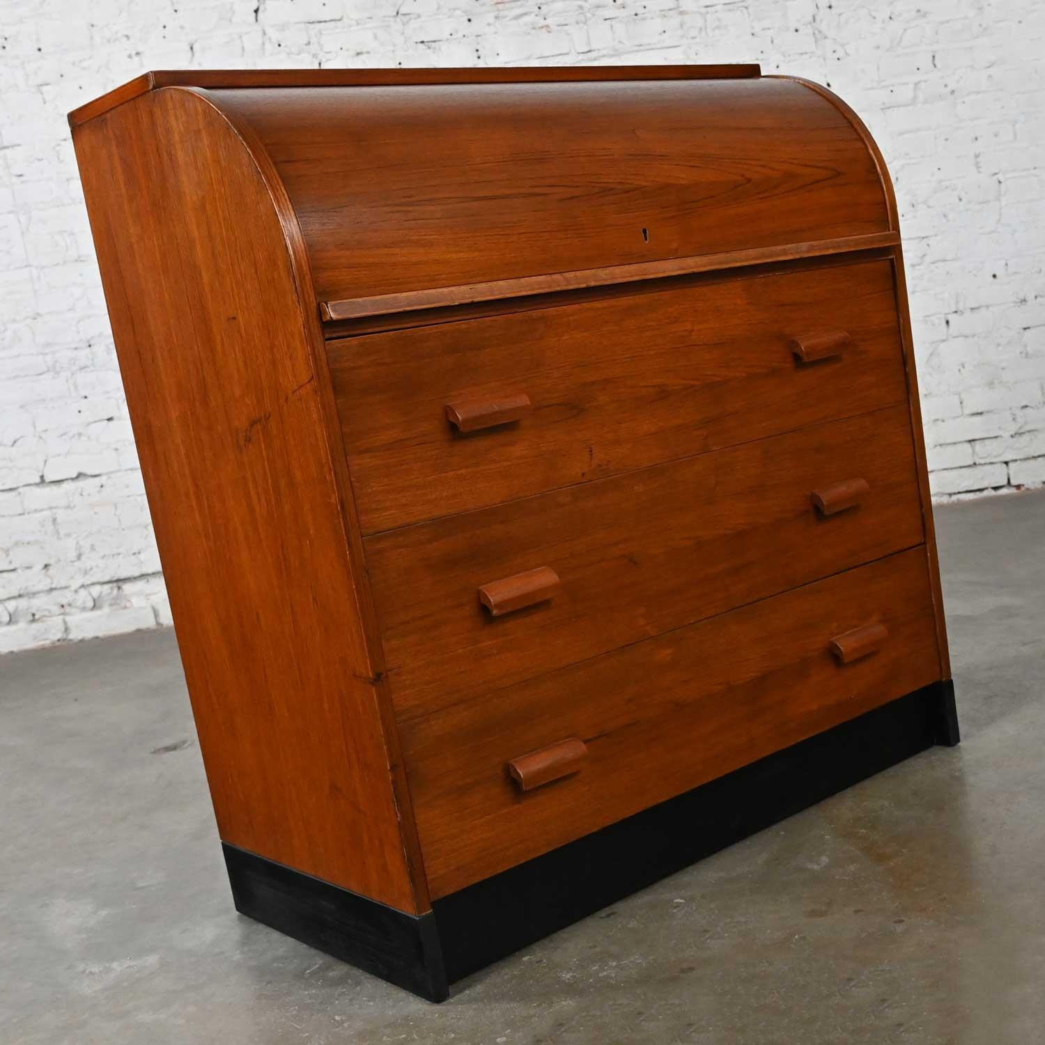 Handsome vintage Scandinavian Modern teak roll top desk or dresser. Beautiful condition, keeping in mind that this is vintage and not new so will have signs of use and wear. It has some visible wear, particularly in the top, so you can see some
