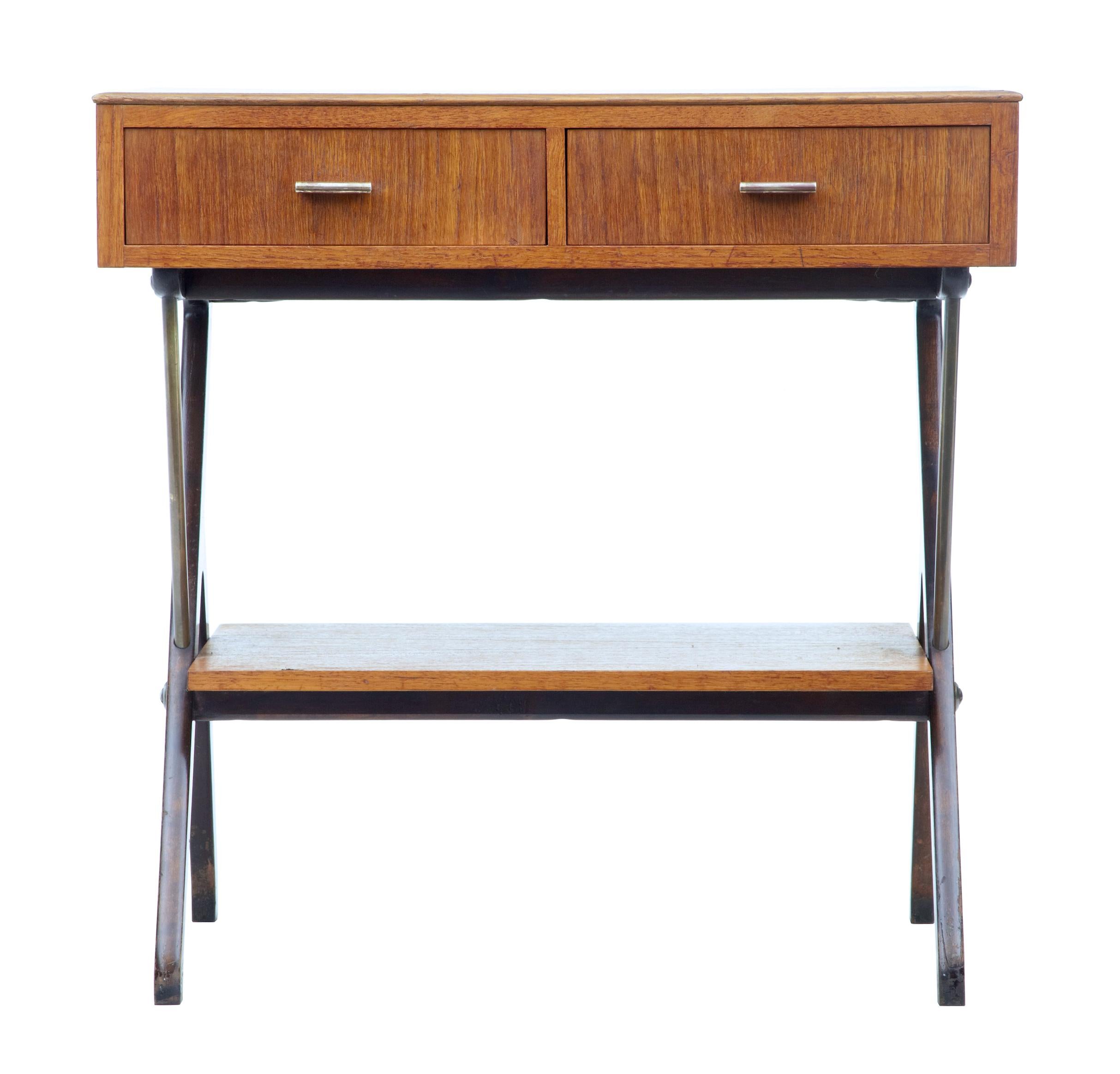 Mid-20th century Scandinavian Modern teak side table, circa 1960.

Teak side table with 2 front drawers. Formica inlaid top and dark stained standing on y frame legs which supports a further storage shelf.

Minor surface marks.