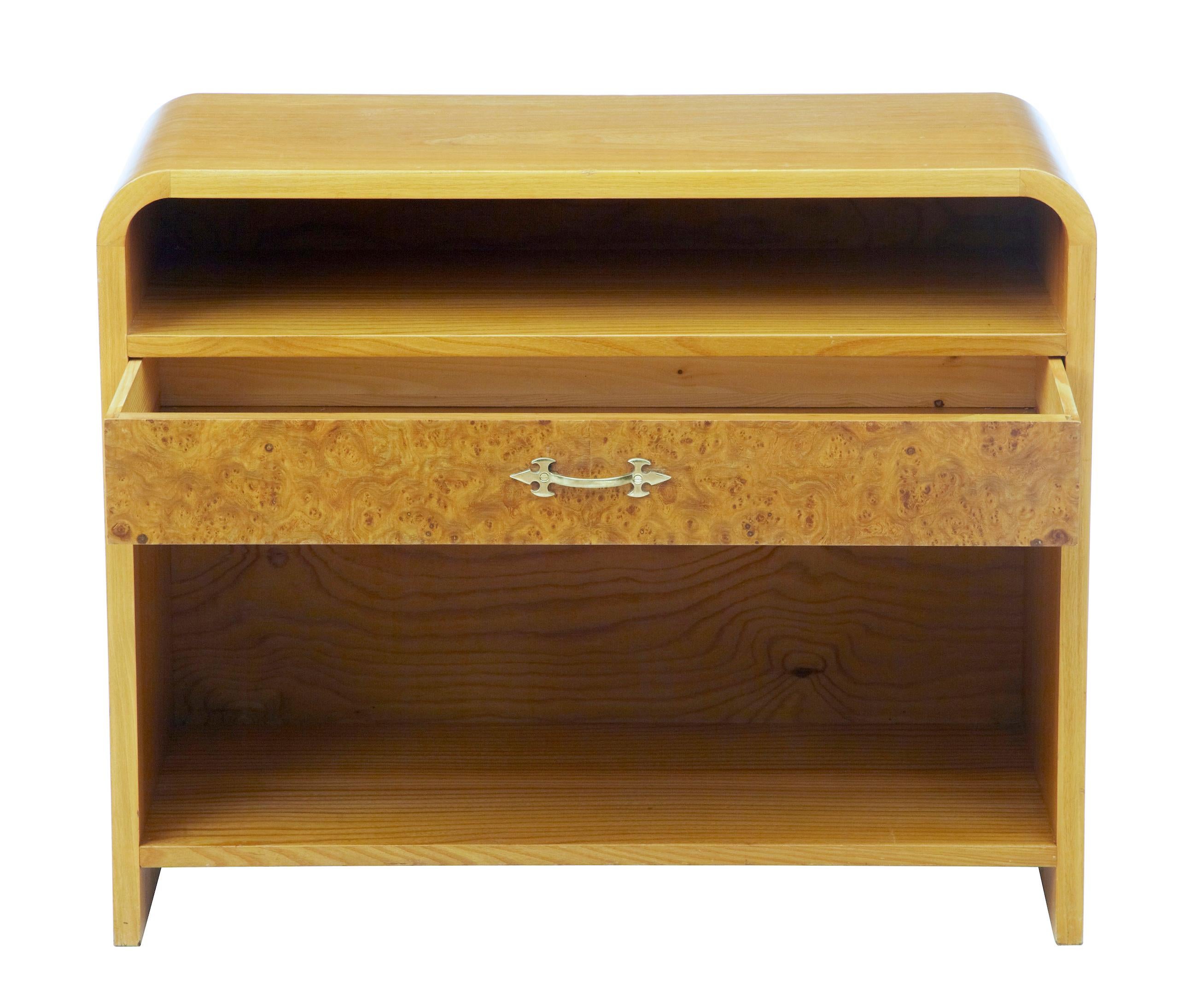 Mid-20th century Scandinavian shaped birch bedside table, circa 1960.

Good piece of Scandinavian Modern furniture, circa 1960. Curved shape sides, with open space below which a burr birch drawer and larger open aperture below.

Evidence of use