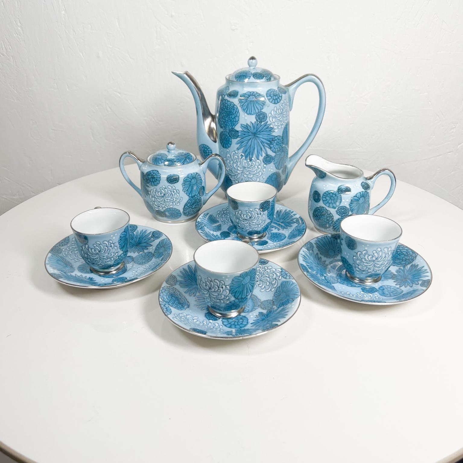 From Japan 11-piece set
Mid 20th Century Sculptural Blue Porcelain Tea Service Set for Four Japan
Teapot, Creamer and Sugar Bowl
With four cups and saucers
Tea pot 7.25 x 3.38 w x 7 h 
Sugar 5 x 3 x 3.5 h 
Creamer 4 d x 2. 63 2.25 h 
Saucer plate