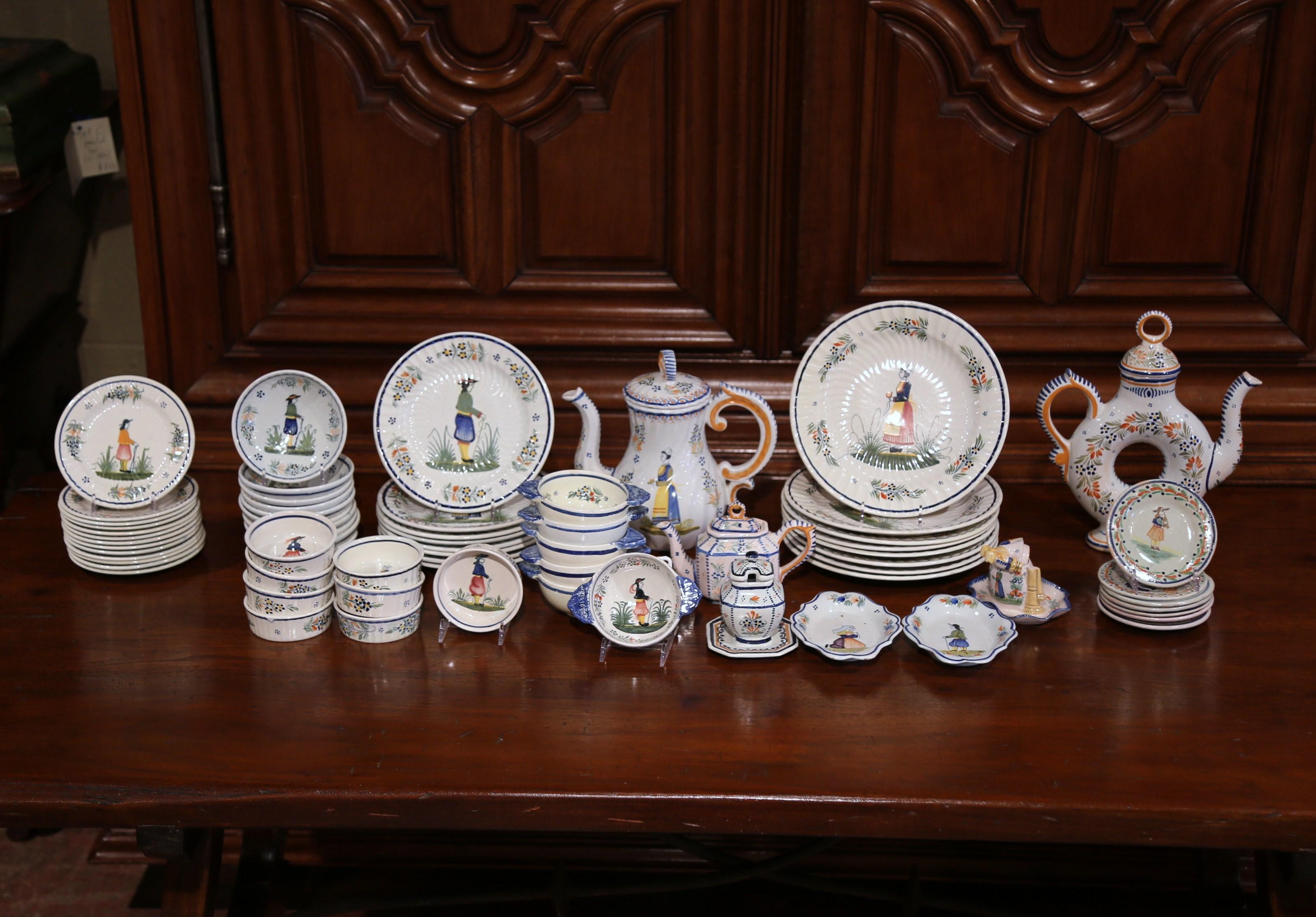 Decorate a kitchen shelving or accessorize a breakfast room vaisselier cabinet with this set of Qimper pottery. The set of about seventy pottery pieces with traditional Breton man and woman figures painted on the front, was crafted and hand painted