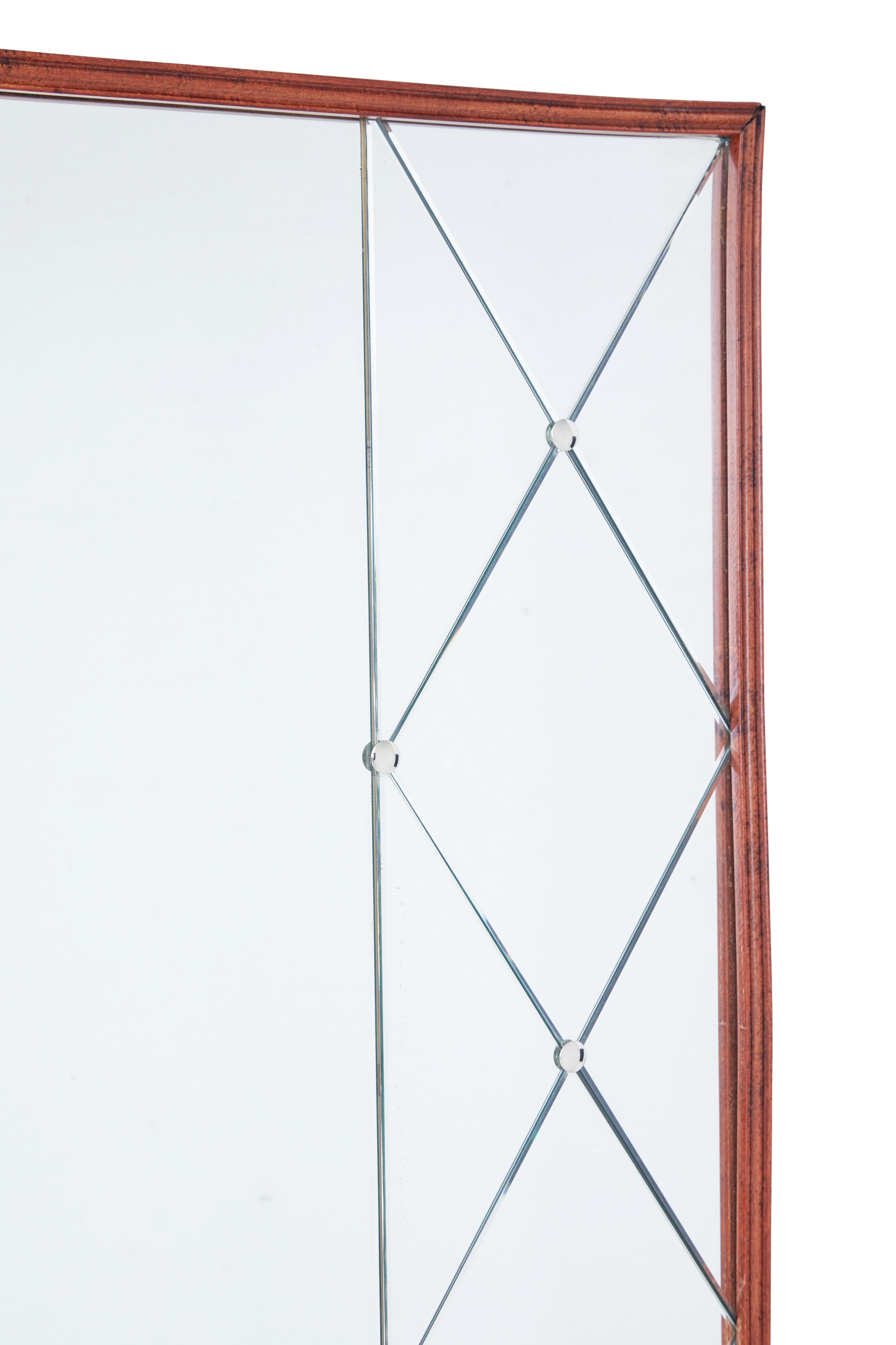 Unusual shaped deco style mirror, circa 1950.

Slight concave shaped teak frame. Central mirrored panel flanked either side with latice mirrored panels. Held in place by screw in steel studs.