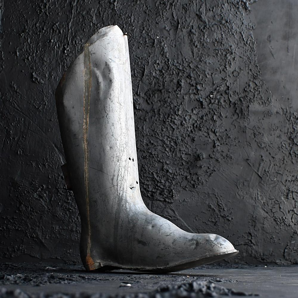 Mid-20th century sheet metal shoemakers trade sign 

A sculptural sheet metal mid-20th century English boot makers shop trade sign. Still with its original loop hanging and side support bracket in place. This item shows signs of originally being