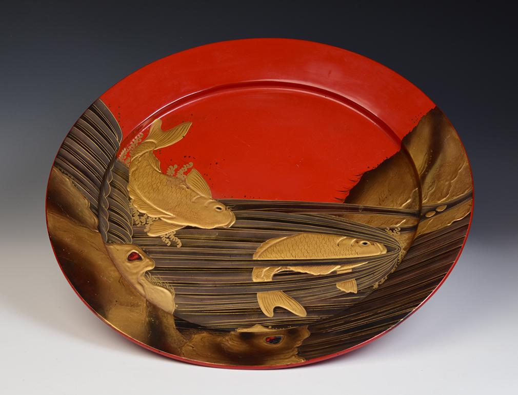 Large Japanese wooden tray with koi carp fish design.

Age: Japan, Showa Period, Mid-20th Century
Size: Diameter 52.7 C.M. / Height 5.6 C.M.
Condition: Nice condition overall.