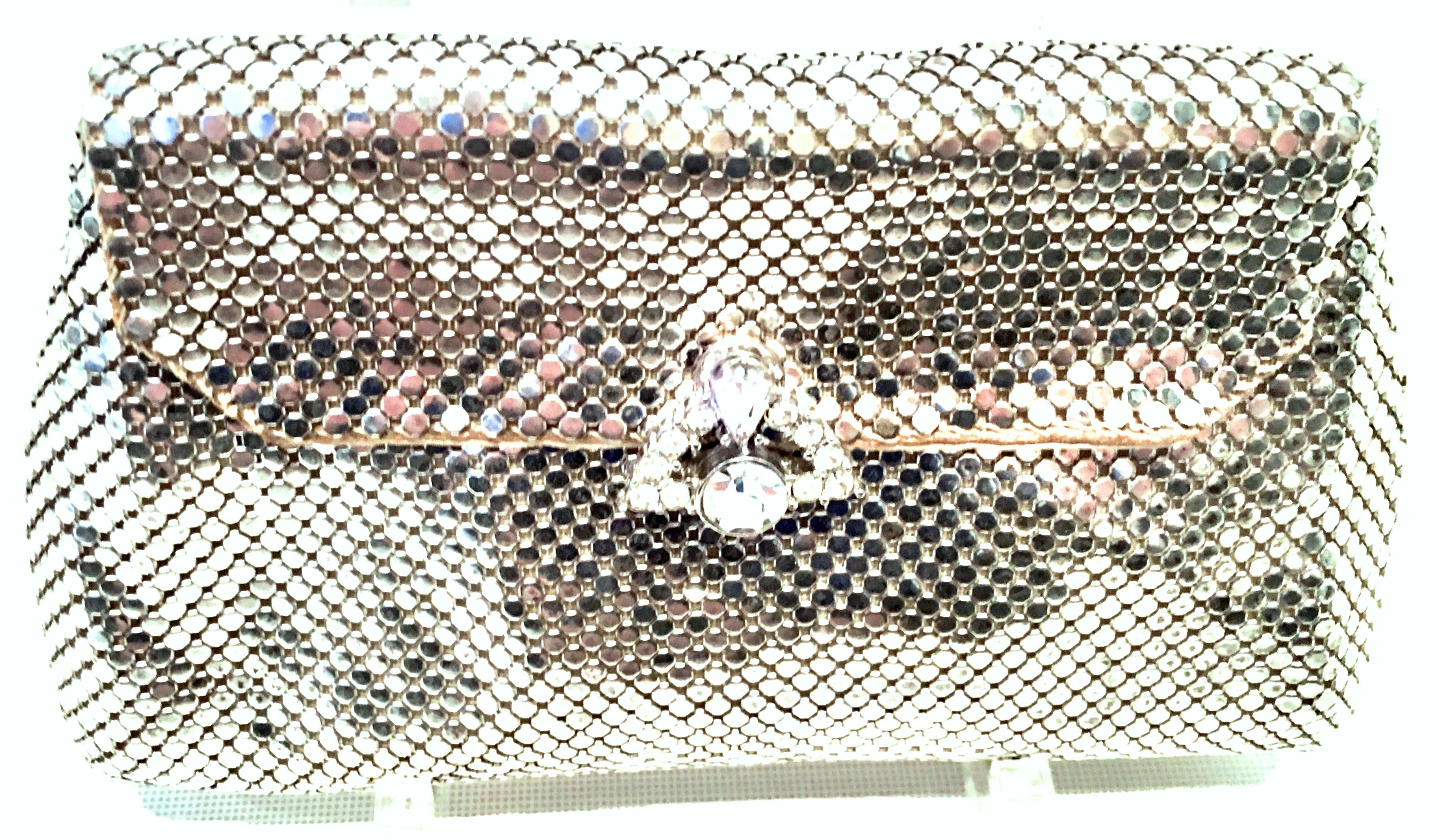 Mid-20th Century Art Deco Silver Metal Mesh & Austrian Crystal Evening Bag By, Whiting & Davis. This finely crafted and coveted piece features a silver and prong set colorless Austrian crystal ornament snap closure. The original Whiting & Davis