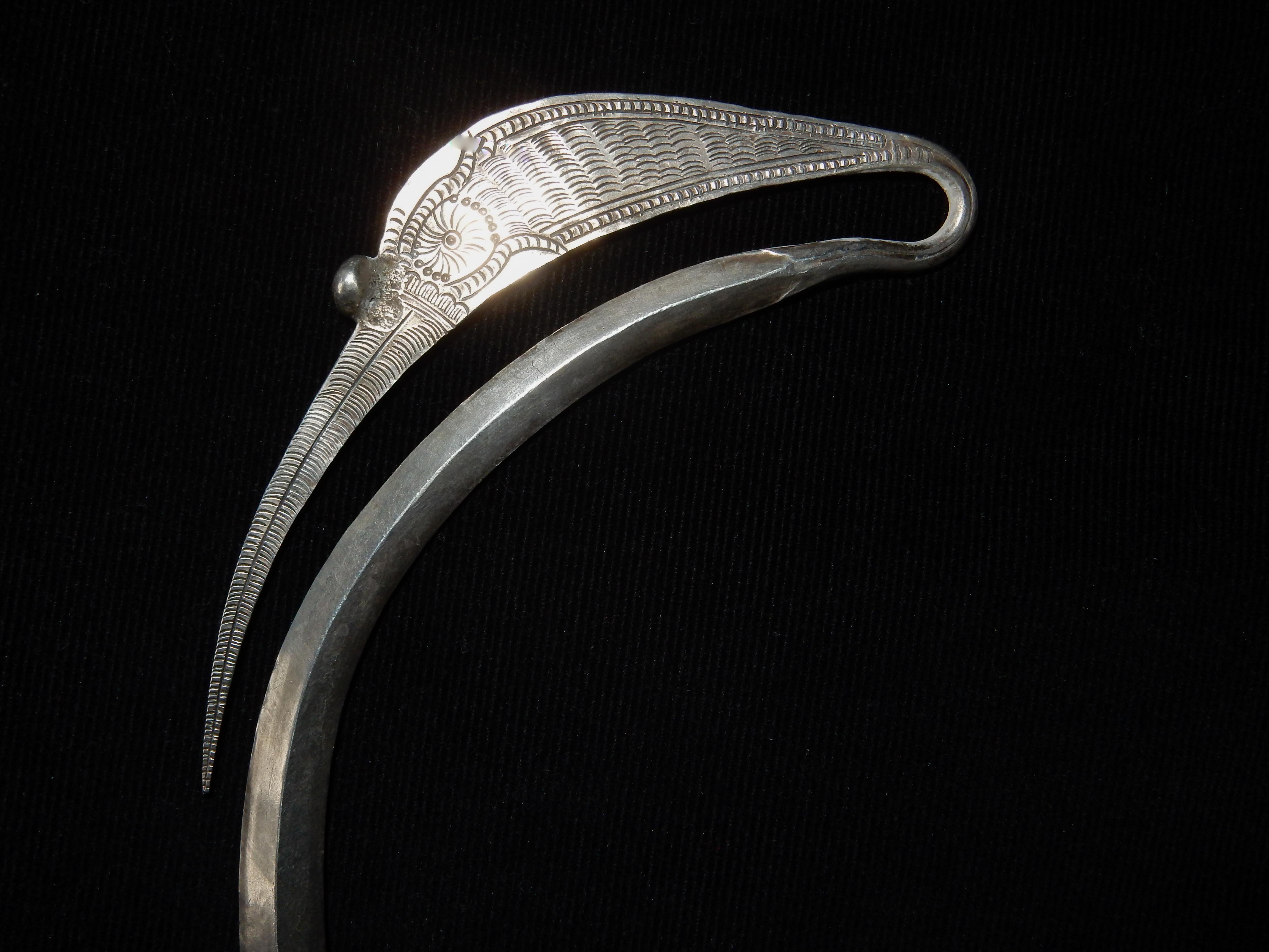 Mid-20th century silver neck-ring. From the Yao or Hmong Ethnic Group of Southeast Asia.
The beauty of this silver choker lies in the grace and simplicity of its form. The shape and engraving of the long flattened ears is evocative of cranes or