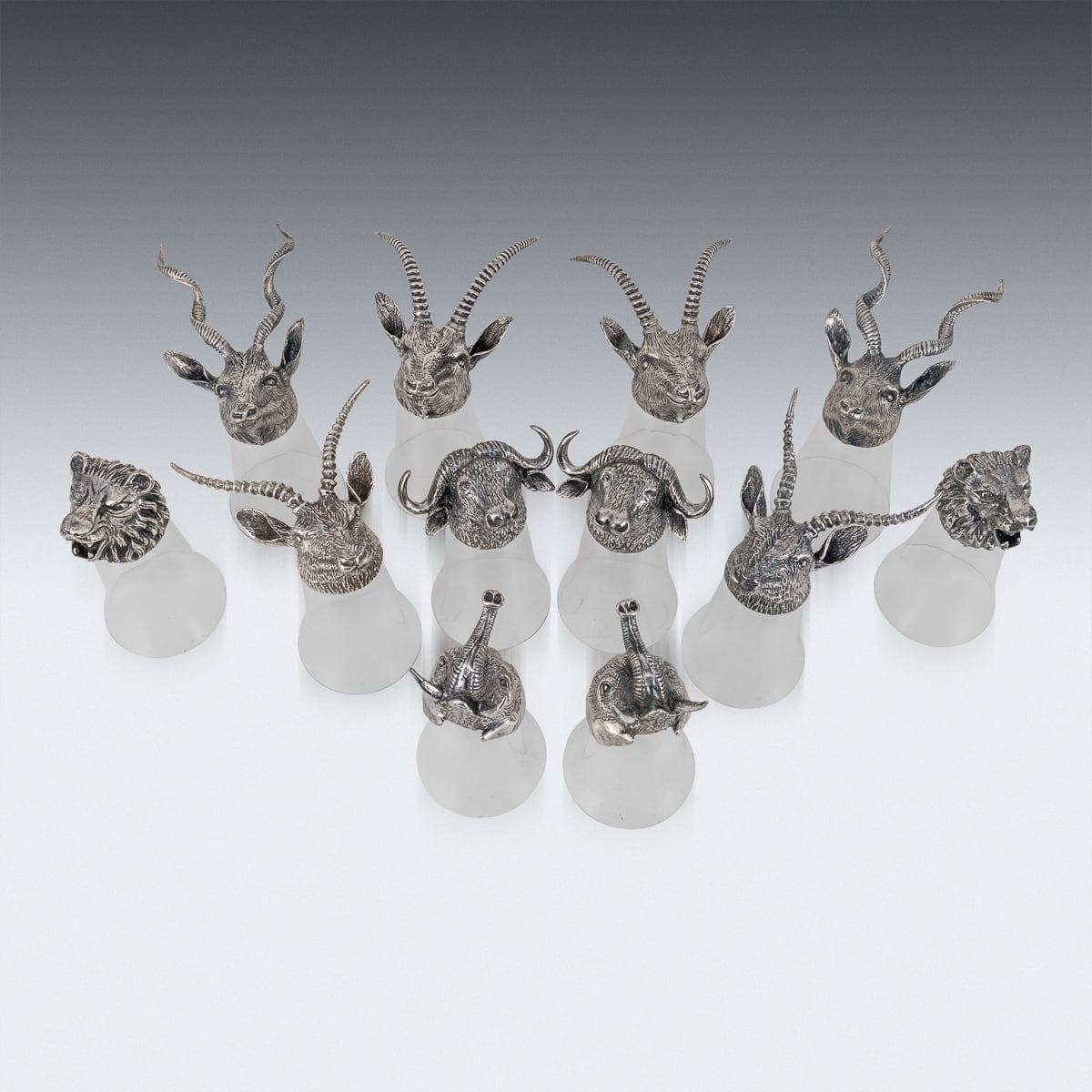 A mid 20th Century Spanish made, collection of stirrup cups and matching jug / carafe, crafted in the 1970's by Valenti. The jug showcases a bulbous glass body adorned with a hinged boar head, with the boar’s tail forming the handle, and is stamped