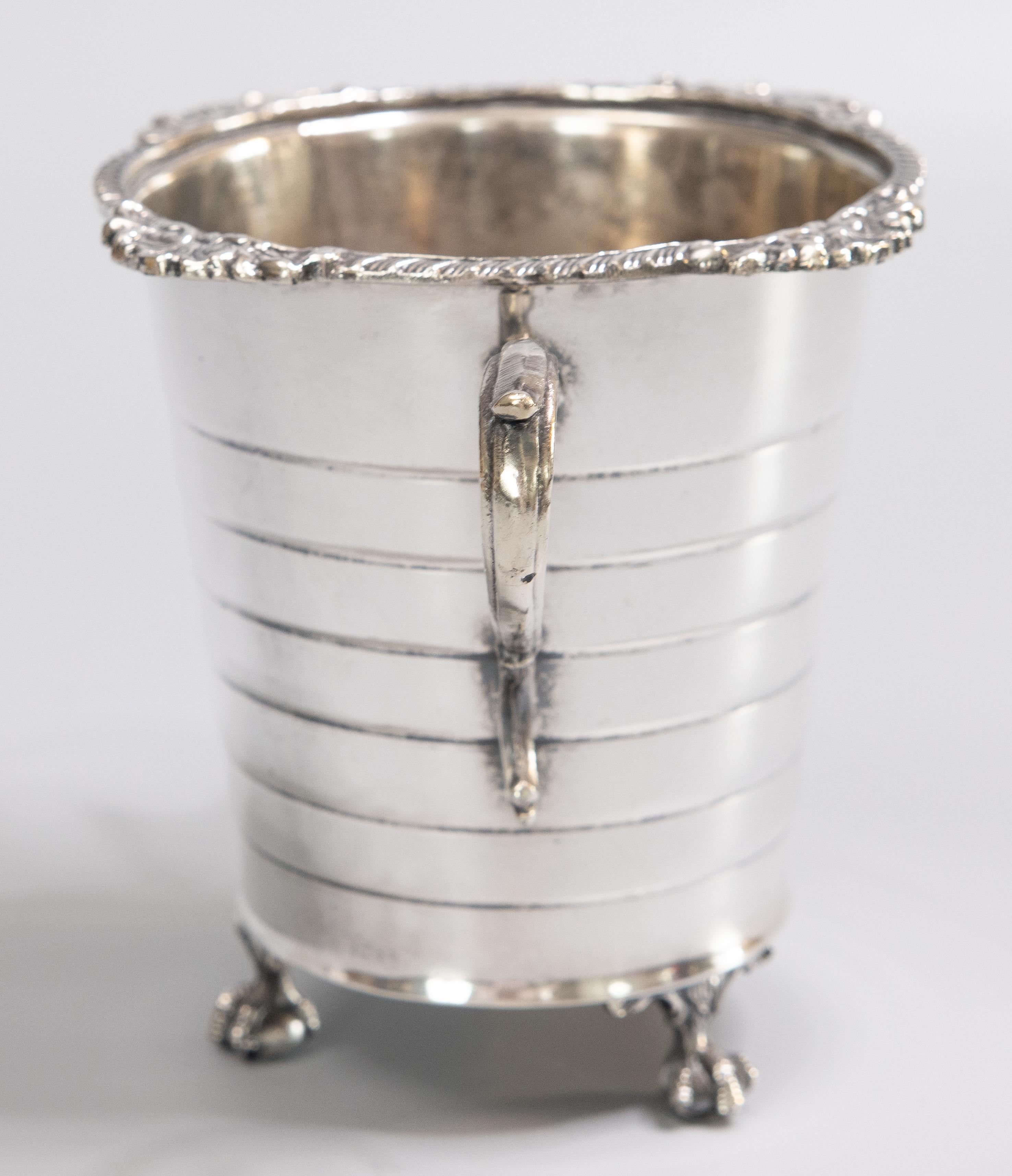 A superb vintage silver plate footed ice bucket. Maker's mark on reverse. This gorgeous ice bucket has a decorative rim, ornate handles, and ball and claw feet. It's perfect as an ice bucket, used for chilling wine, or could also be used as a