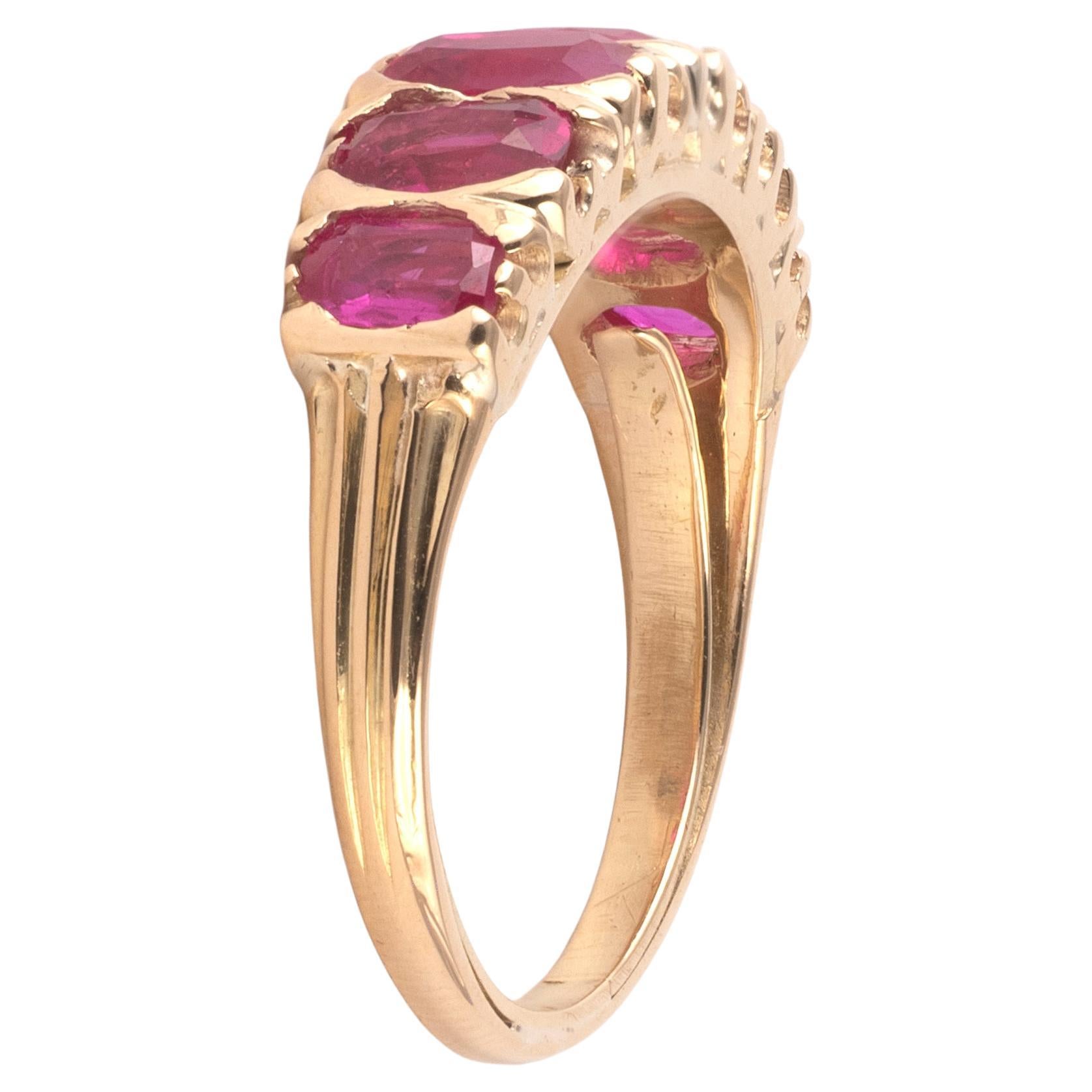 Mid-20th century six stone ruby ring, c.1940, with graduated oval cut Burma rubies, approximately 3.05cts in all, claw set in gold, accompanied by LAG report no. 119629 giving the Burma origin opinon and that the stones show no evidence of heat