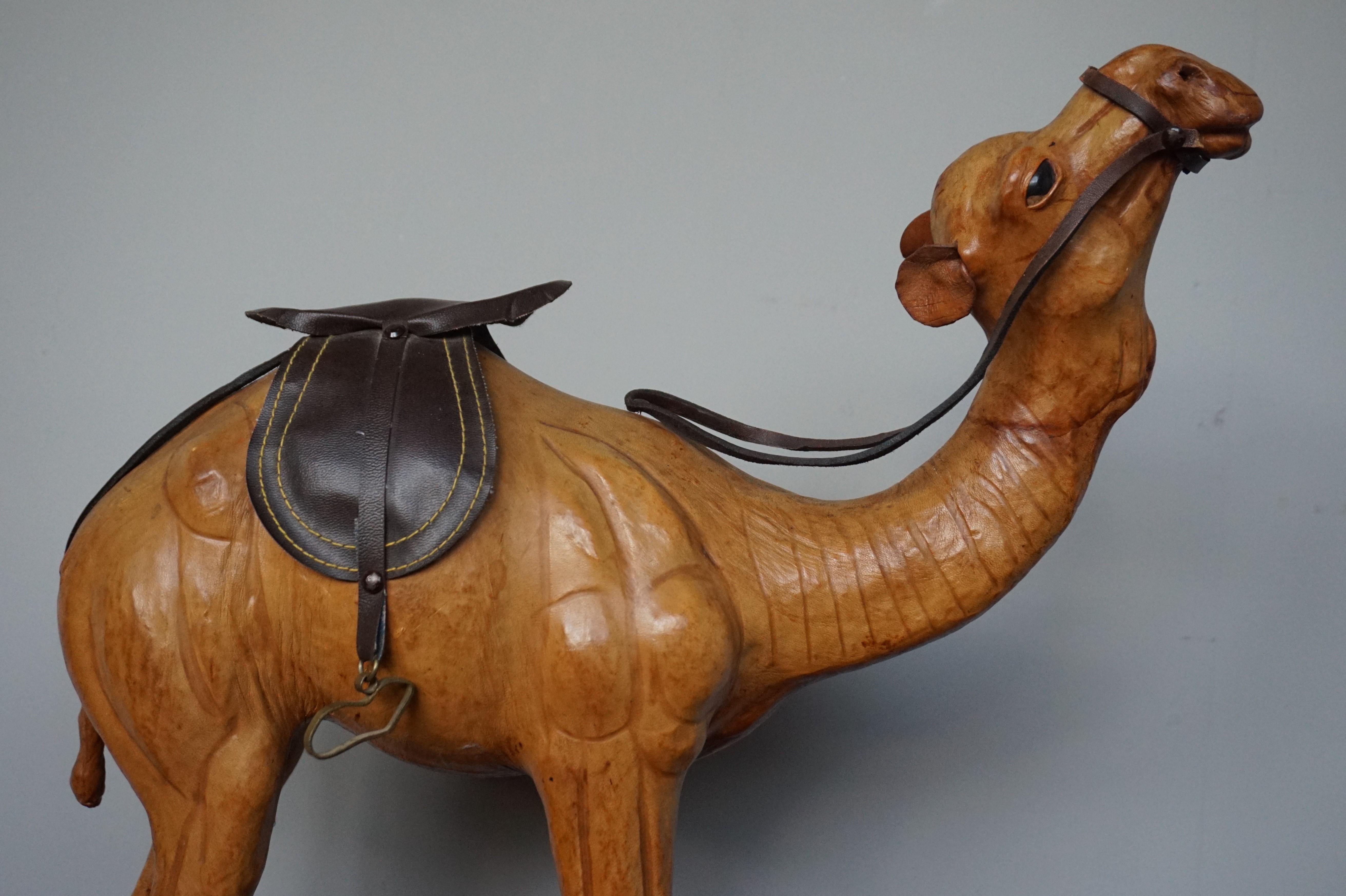 Good size and highly decorative camel or dromedary sculpture, mid-20th century.

This full-grown and very realistic dromedary has both great aesthetic and decorative value. Underneath the leather hide is a very well carved wooden sculpture which is
