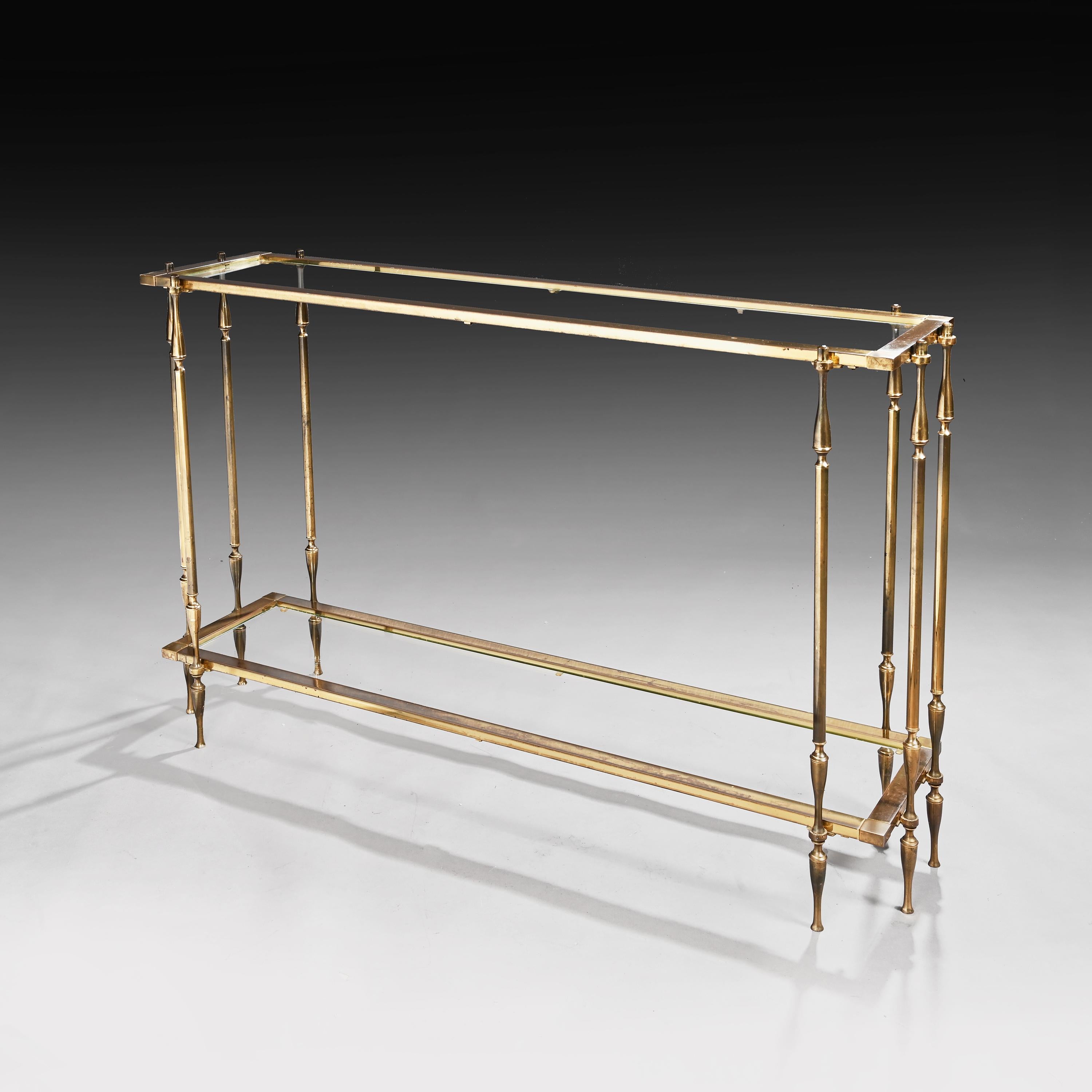 A very good quality and unusual mid-20th century brass and glass two tier console table.

Spanish, circa 1960.

Of rectangular form, with the brass work having a wonderful patina, the top inset with glass held by eight turned brass supports with