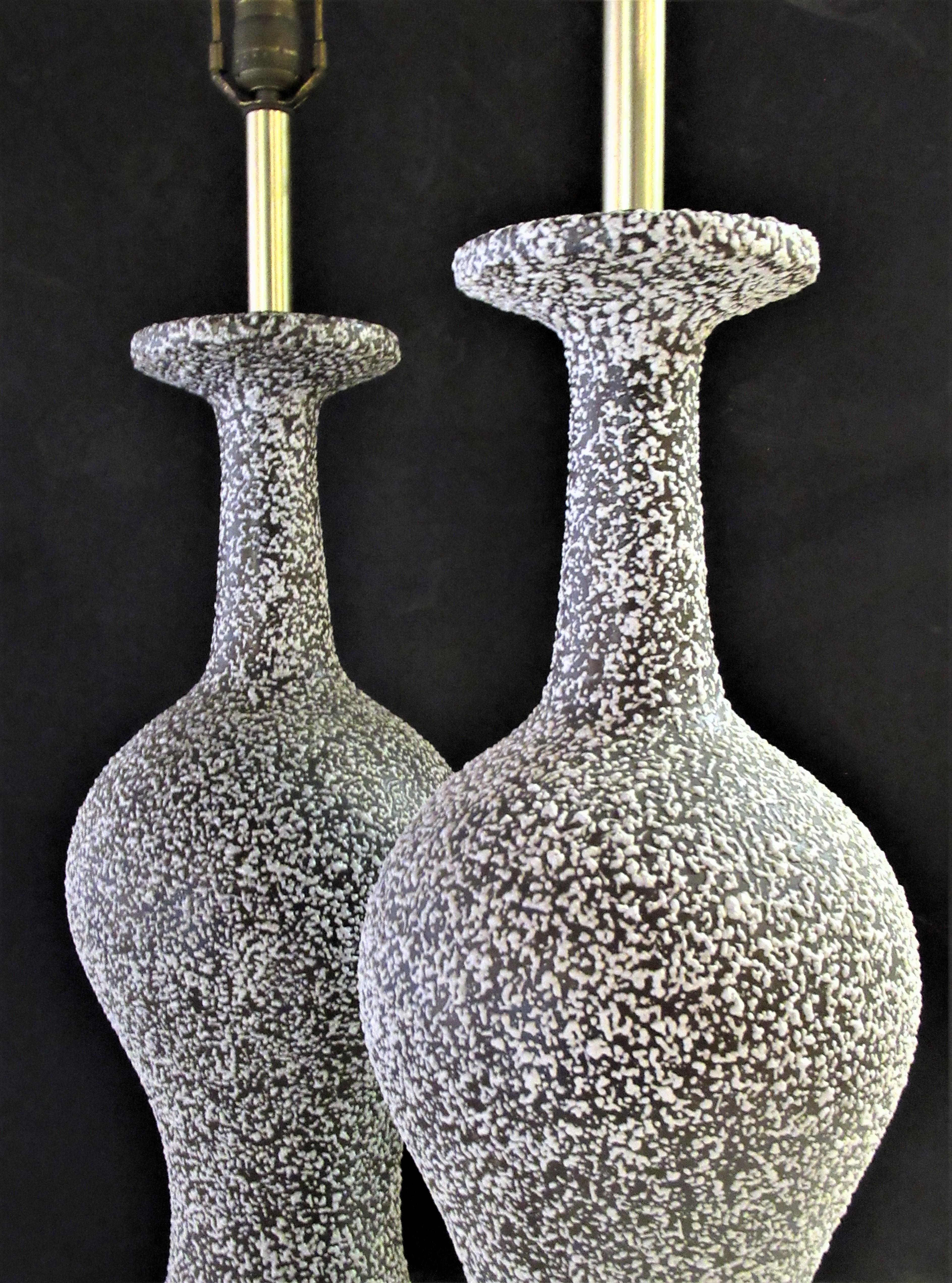 A pair of finely textured speckle glazed ceramic table lamps with a great looking tall elongated neck bottle form. Very good quality. Circa 1950. Beautiful lamps. Look at all pictures and read condition report in comment section.