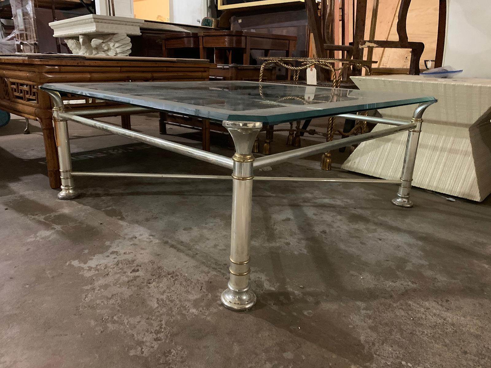 Mid-20th century square silver metal and brass coffee table with glass top.