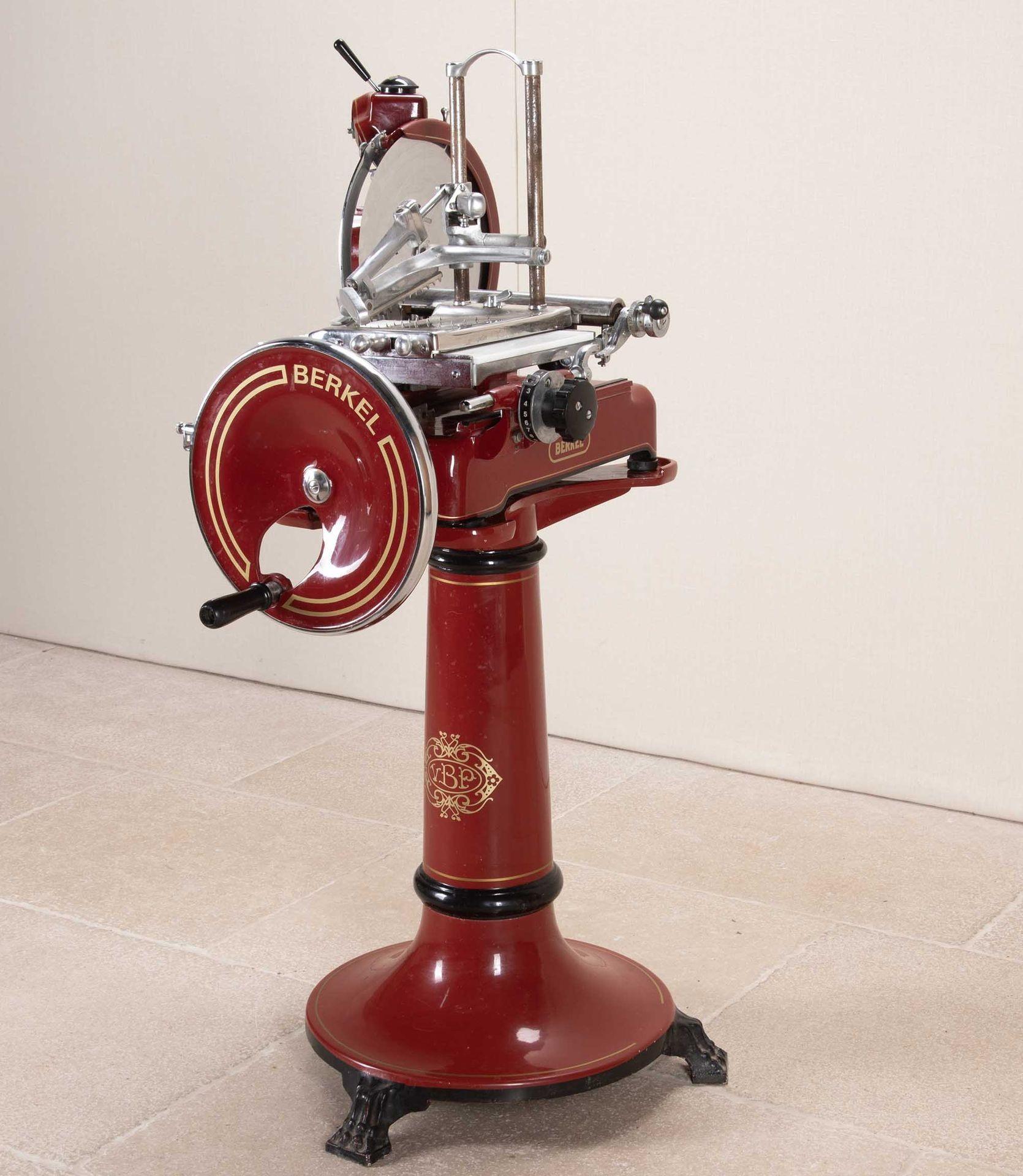 A mid-20th Century Dutch steel meat slicer. In red on central pedestal support in working order, in very good condition. Prominently displays the manufacturer's name, 'Berkel'. Circa 1950.