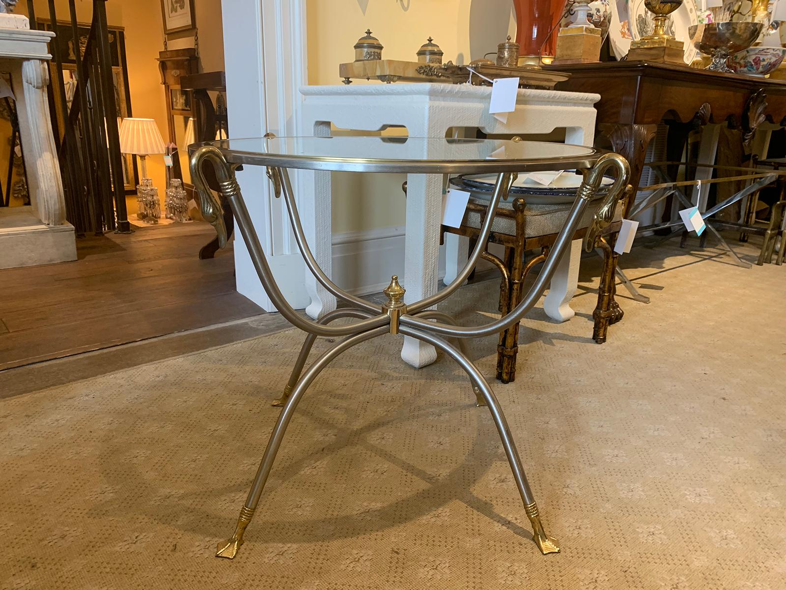 Mid-20th century steel and brass gueridon glass top table, ducks heads and feet.