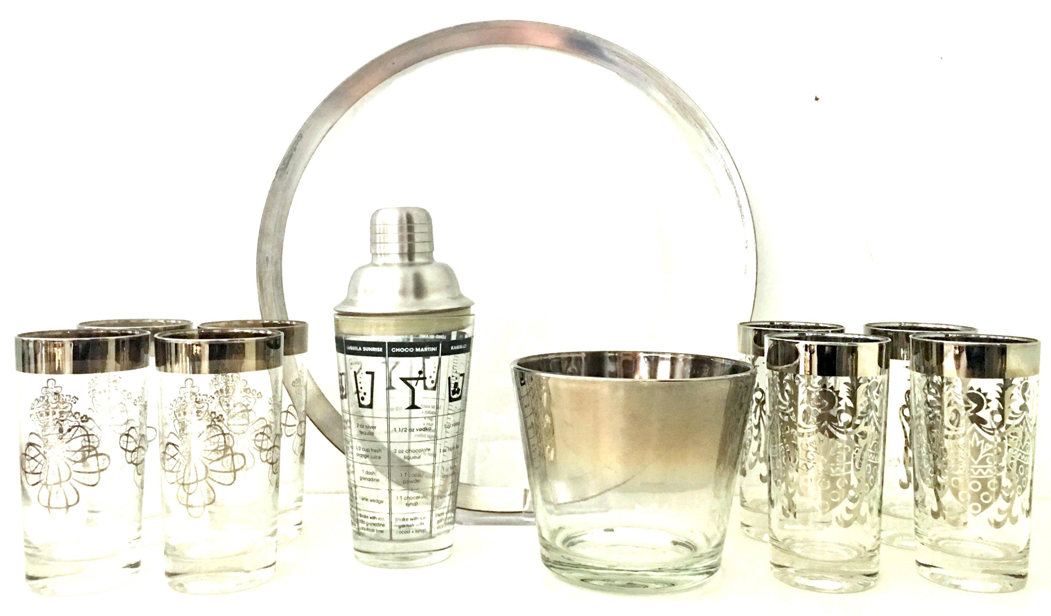 Mid-20th Century Sterling silver and glass drinks set of eleven pieces by, Dorothy Thorpe. Set includes 1 round glass tray with sterling silver edge, 8 high ball drink glasses with sterling silver  overlay , 1 ice bucket with sterling silver overlay
