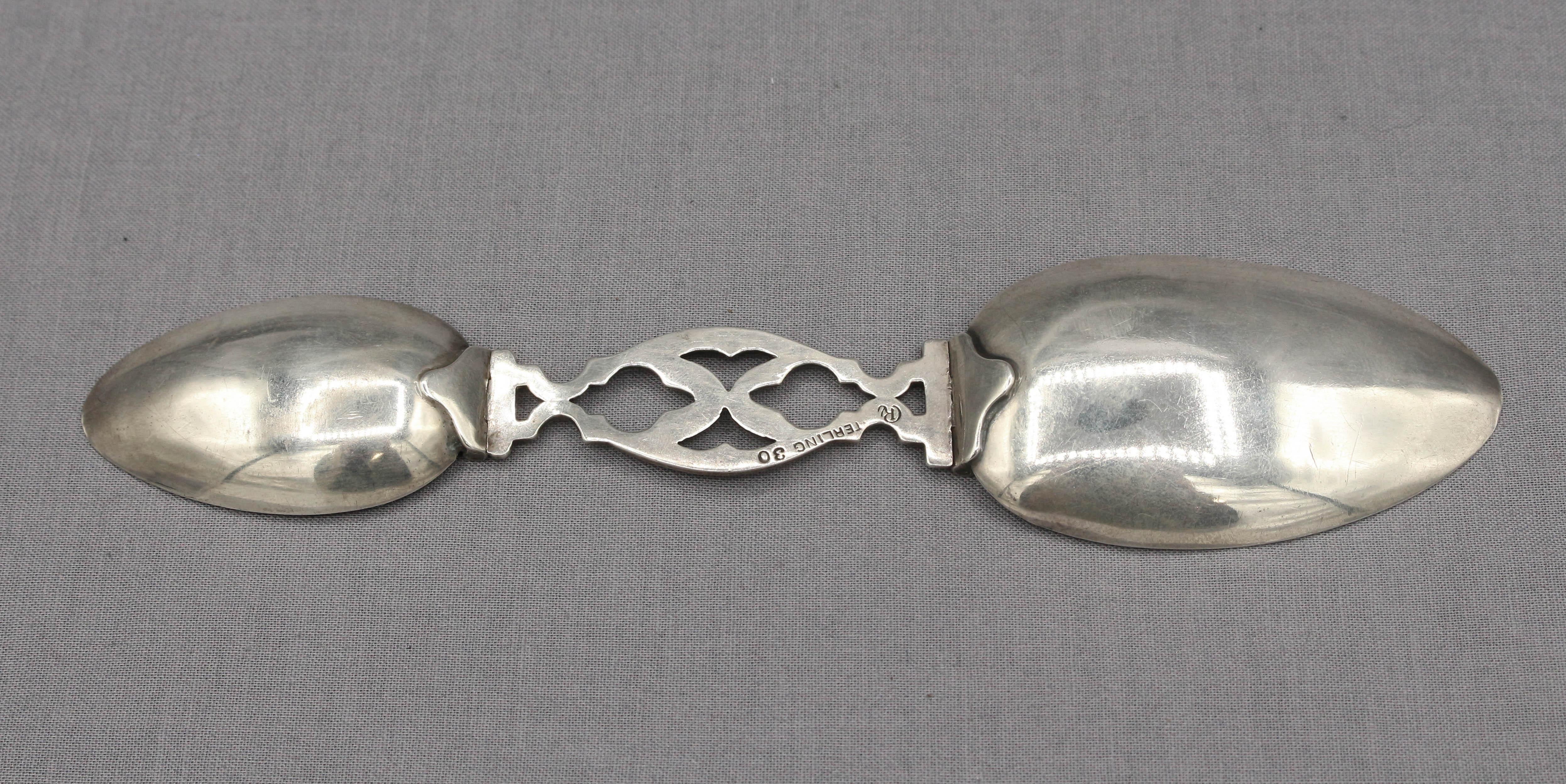 Mid-20th century sterling silver folding medicine spoon, teaspoon & tablespoon, with Gothic cutwork shaft. Made by Currier & Roby, NY, NY. Currier was an early expert & author on American silver (Marks of Early American Silversmiths, 1936). The