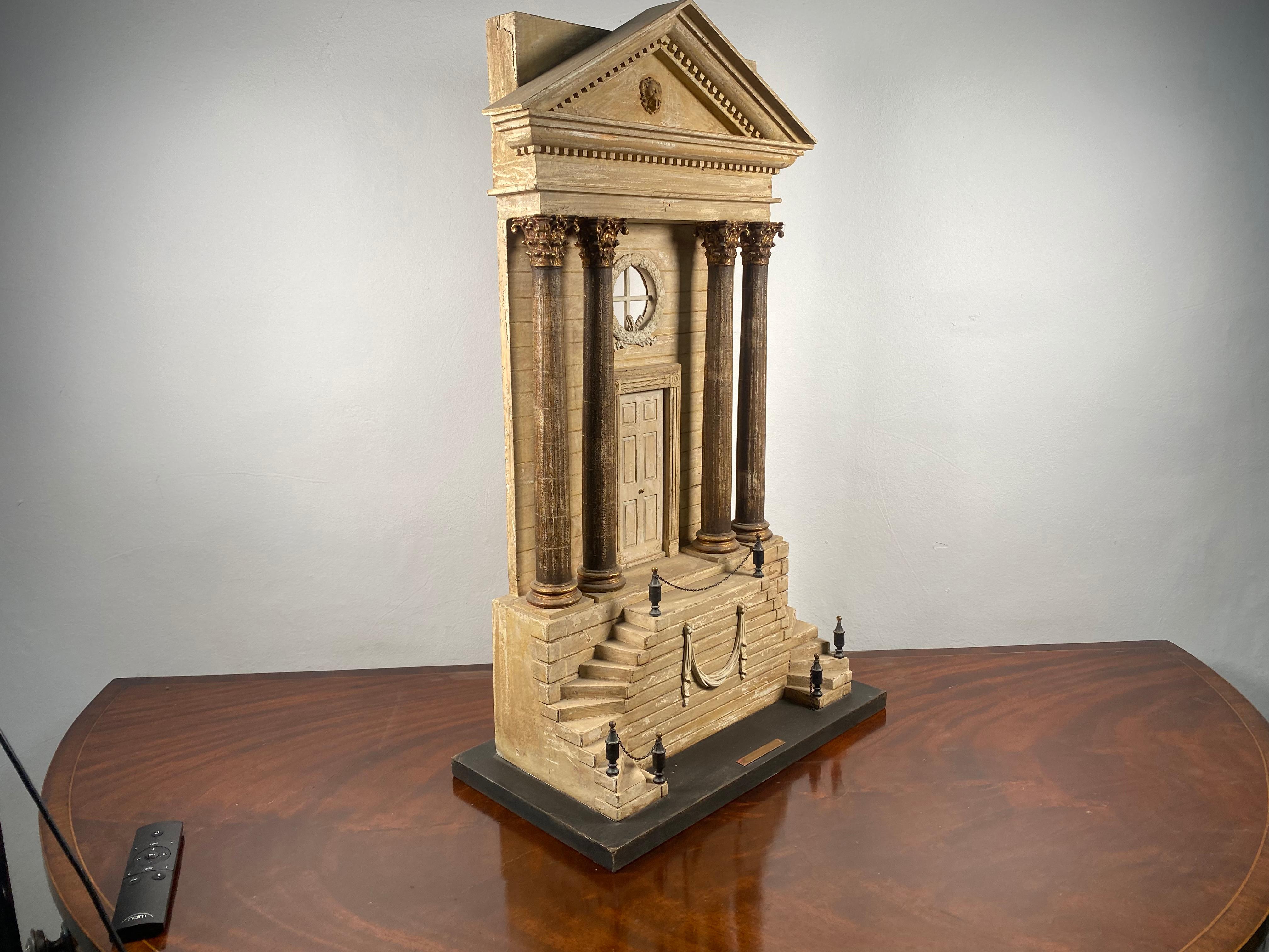 A fantastic mid 20th century model of a typically grand roman entrance. The large proportions of this piece make it a very eye-catching centre piece. Carved mostly in what seems to be a hard plaster with certain metal elements.