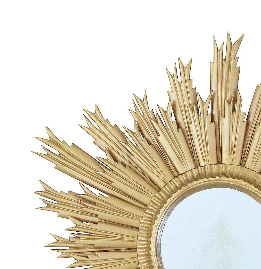 Mid-20th century sunburst mirror, circa 1950.

Good quality Art Deco influenced sunburst mirror, later re-painted in a gold effect. Circular mirror.

Some marks and small losses to wood. Some wear to mirror plate.