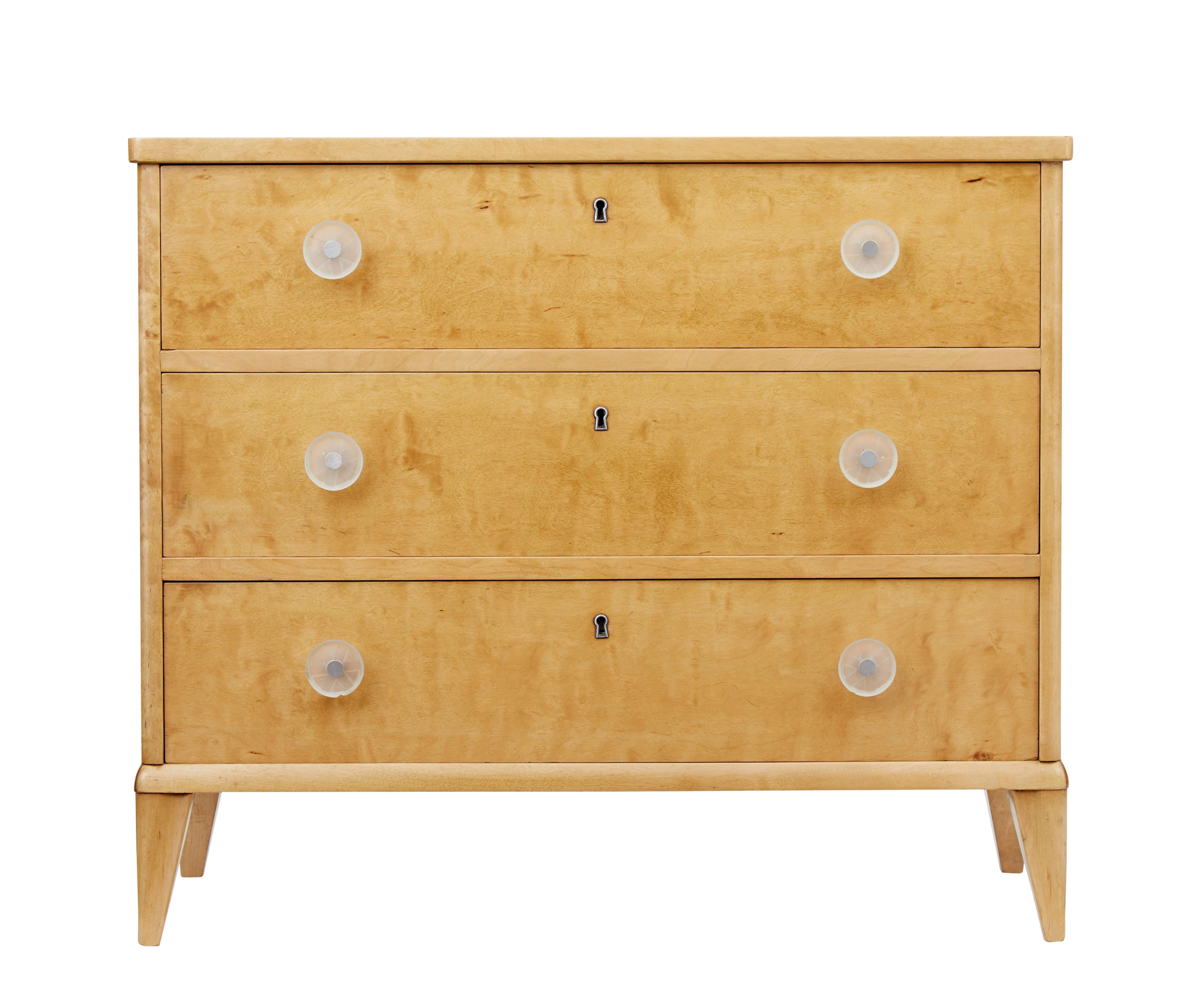 Simple but elegant Scandinavian birch chest of drawers, circa 1950.

3 drawers fitted with decorative etched plastic handles. Rich golden color, standing on tapered feet.

Recently re-polished in our workshop.

Minor surface marks and minor