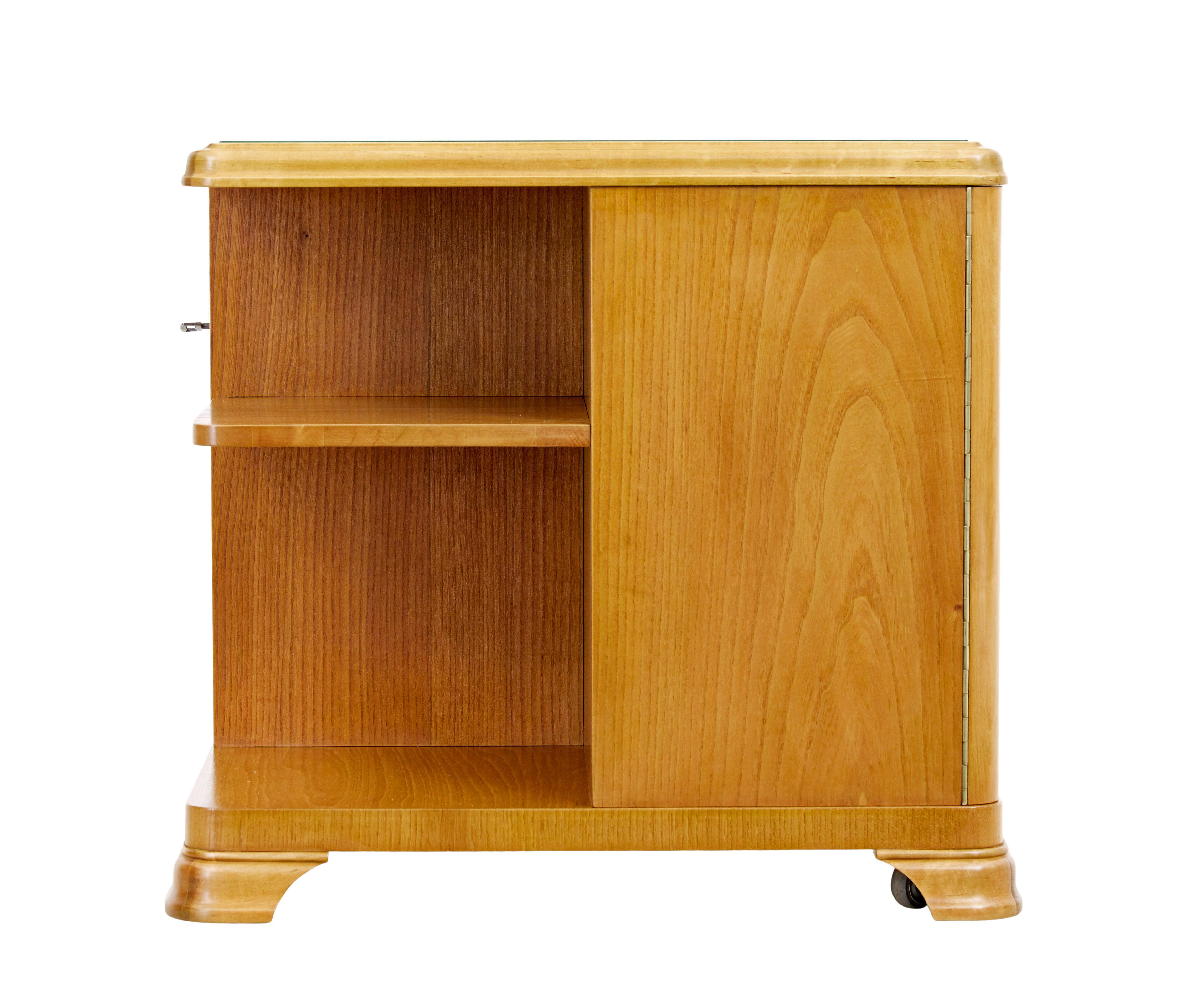 Mid 20th century Swedish elm coffee table circa 1960.

Unusual piece of mid century furniture, which offers a feature for storage on all 4 corners.  Features 2 lockable cupboards with interior shelves, 1 external drawer with storage top and bottom