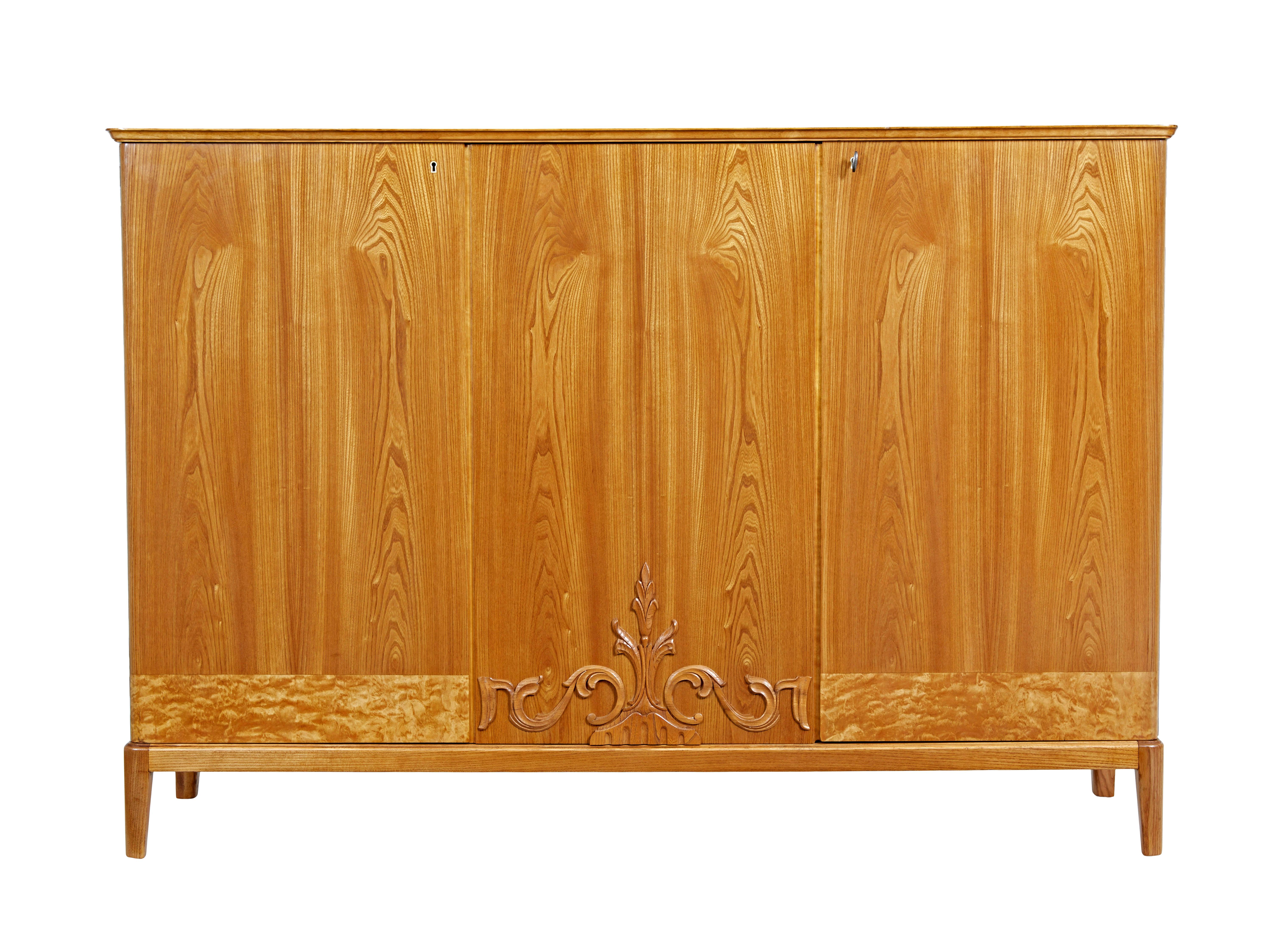 Mid 20th century Swedish elm sideboard circa 1940.

Fine quality Scandinavian elm sideboard in the art deco taste.  Providing double door and single door storage space.  Double doors open to reveal 2 shelves either side of a central partition.  3