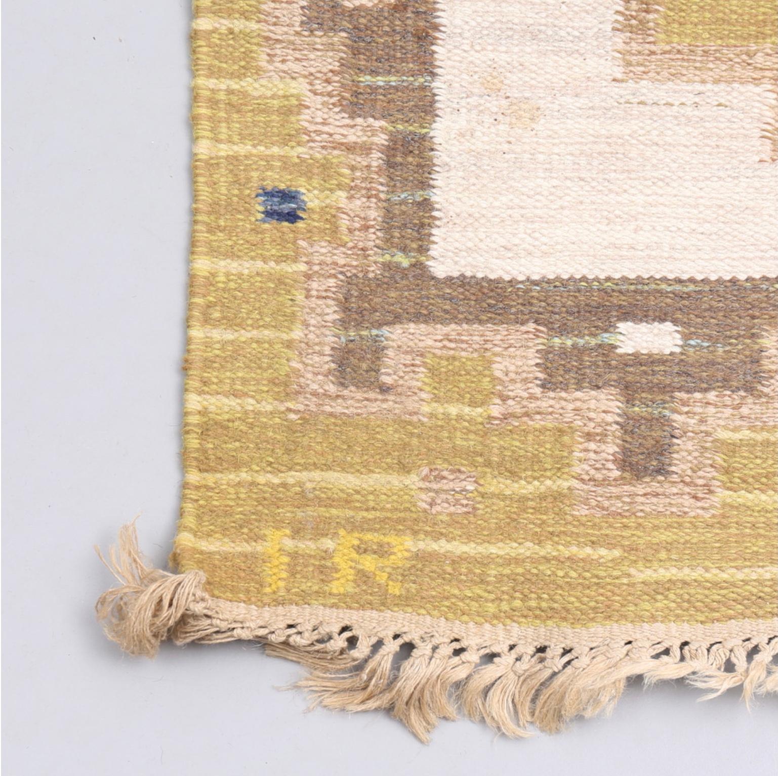 Un delizioso tappeto svedese a trama piatta della metà del XX secolo.

Presenta tre forme geometriche allungate in giallo e blu su uno sfondo color crema, incorniciato da un bordo decorativo giallo e marrone medio.
Con le iniziali dei maker di IR