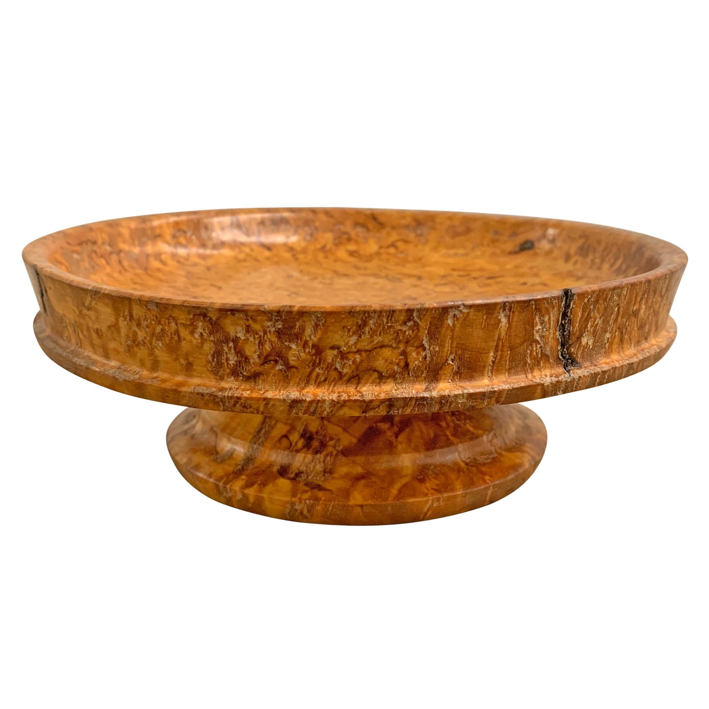A beautiful mid-20th century Swedish turned burl wood dish with a raised edge detail and a fantastic grain pattern with a golden hue.