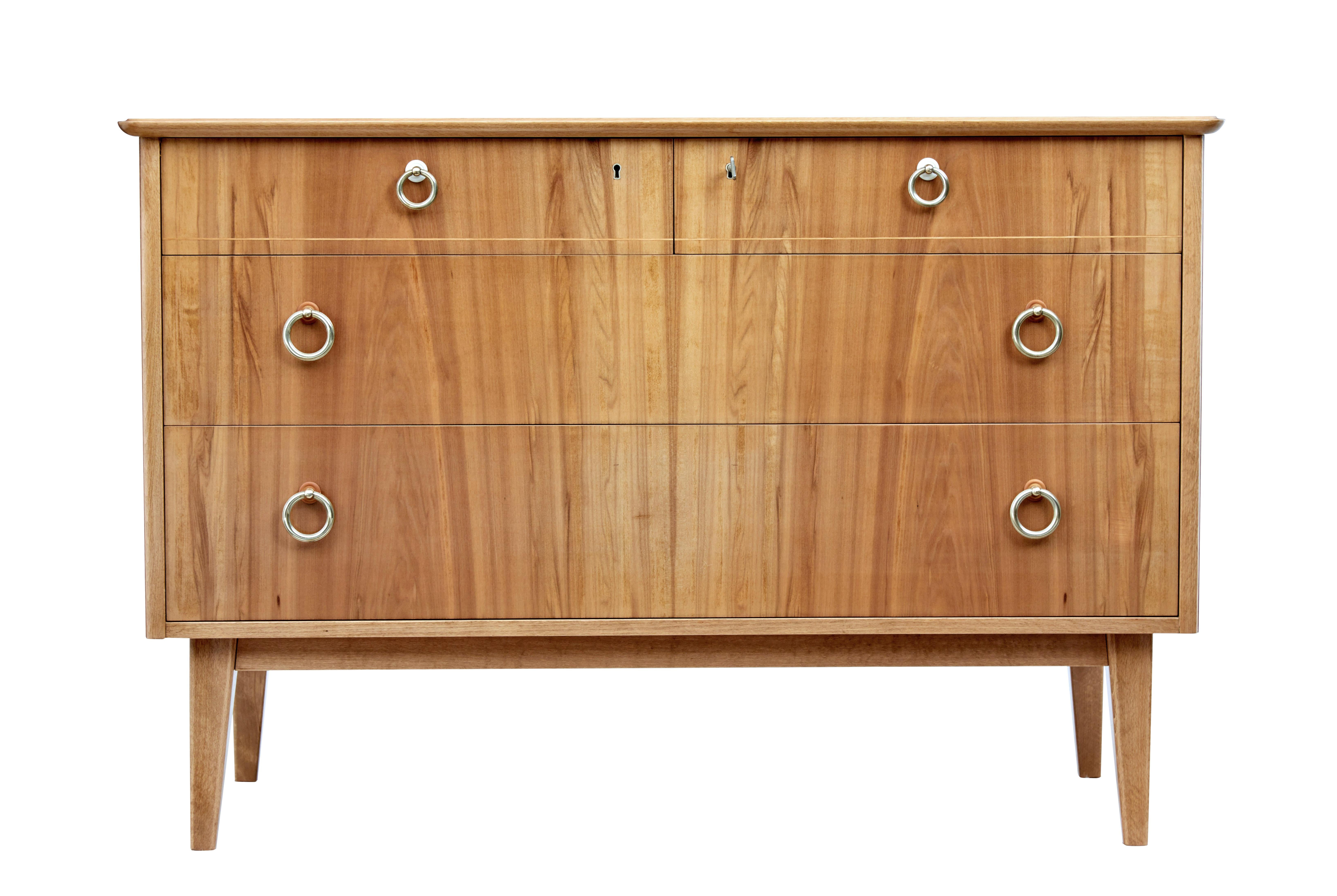 Mid-20th century Swedish walnut chest of drawers by Bodafors, circa 1950.

Good quality chest of drawers finished in light walnut. Fitted with 4 graduating drawers in a 2 over 2 layout, complete with original brass ring handles. Stringing detail