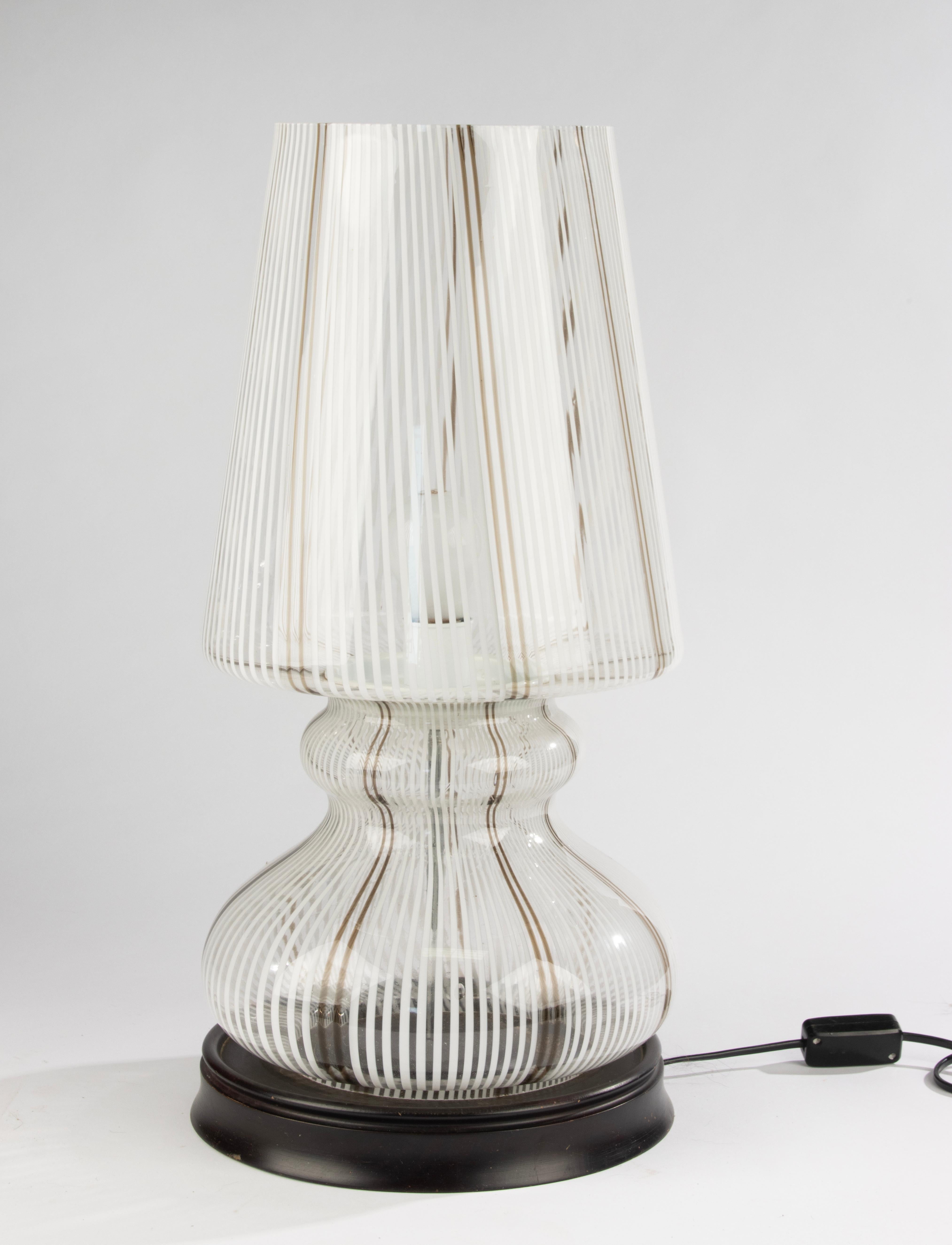 A striking large Murano glass table lamp, dating from the mid-20th century. The hand-blown glass features elegant white and brown striping in a curvaceous form, mounted on a wooden base. The piece combines classic Murano craftsmanship with a bold