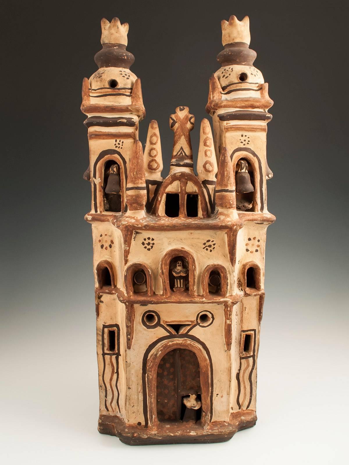 Offered by Zena Kruzick
Mid-20th century tall ceramic Mexican Folk Art Church 
Measures: 21