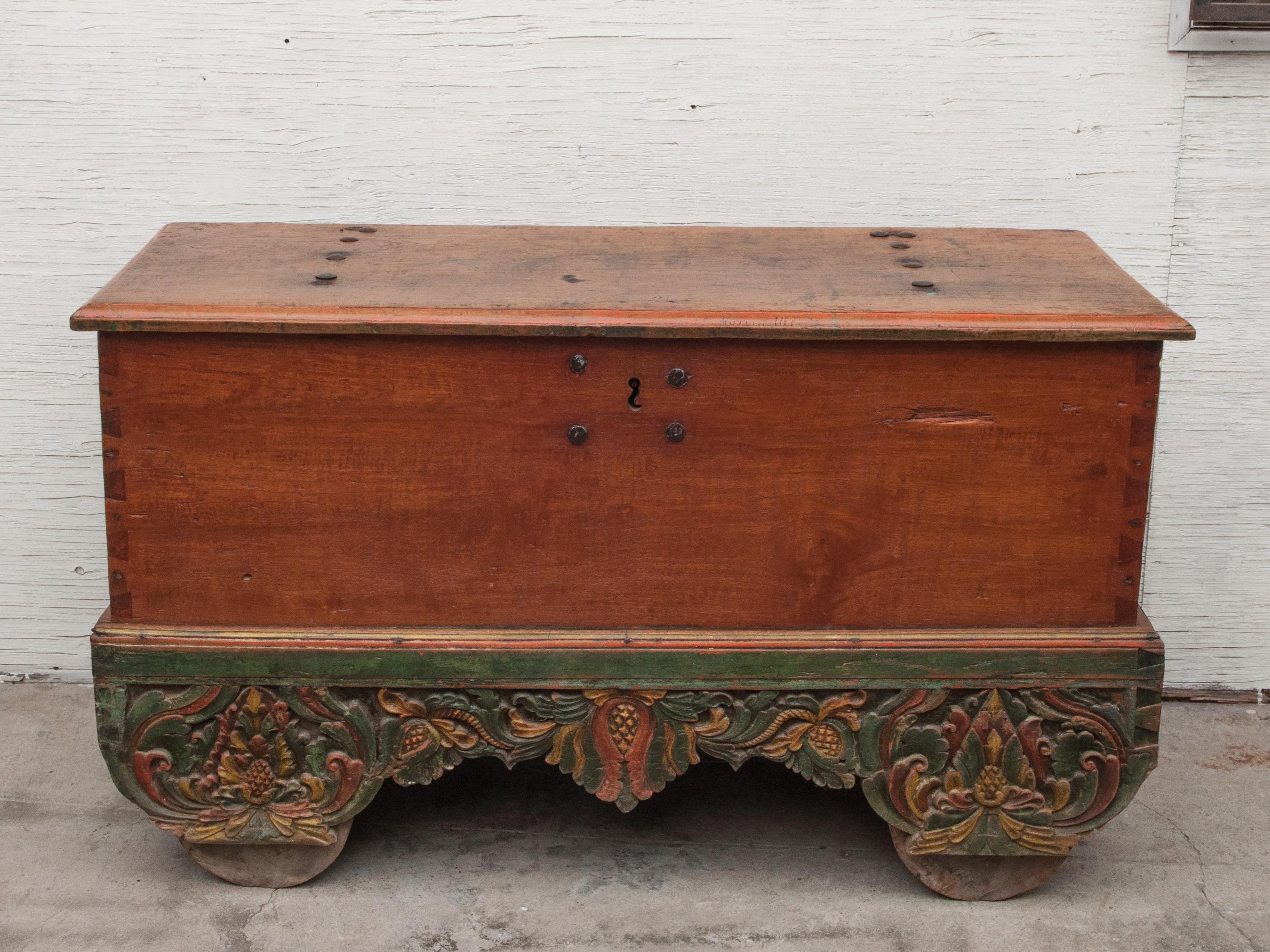 Mid-20th century teak chest on wheels from Java. Original color and hardware. Measures: 56