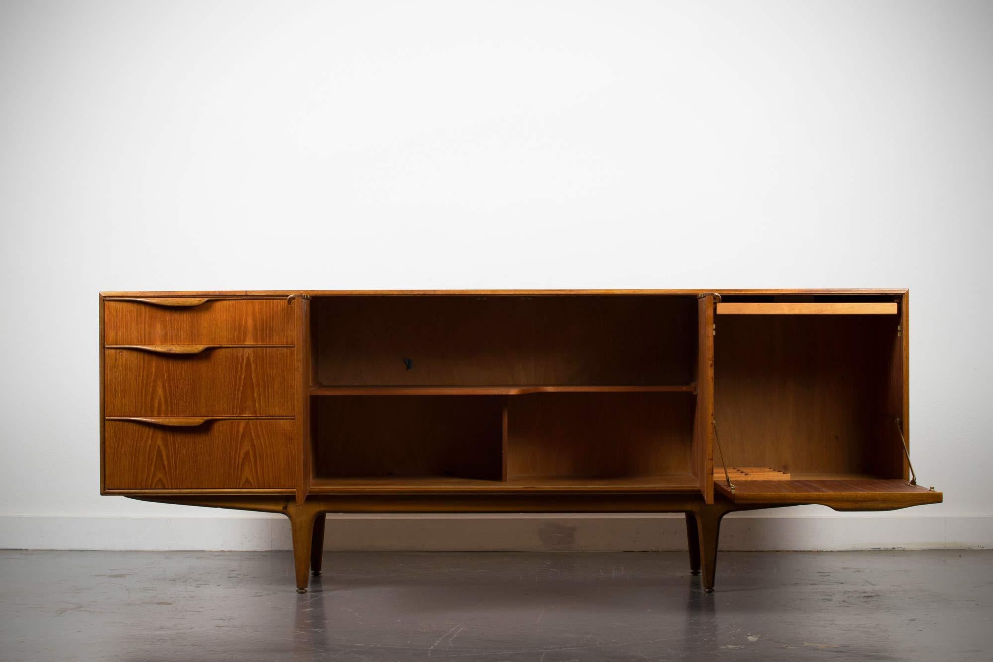 A stunning original vintage mid-1960s sideboard by McIntosh, model name Dunvegan.
It's a beautifully styled and high quality piece made using a mix of solid and veneered teak wood with a lovely grain, there's 3 drawers to the left side with the top