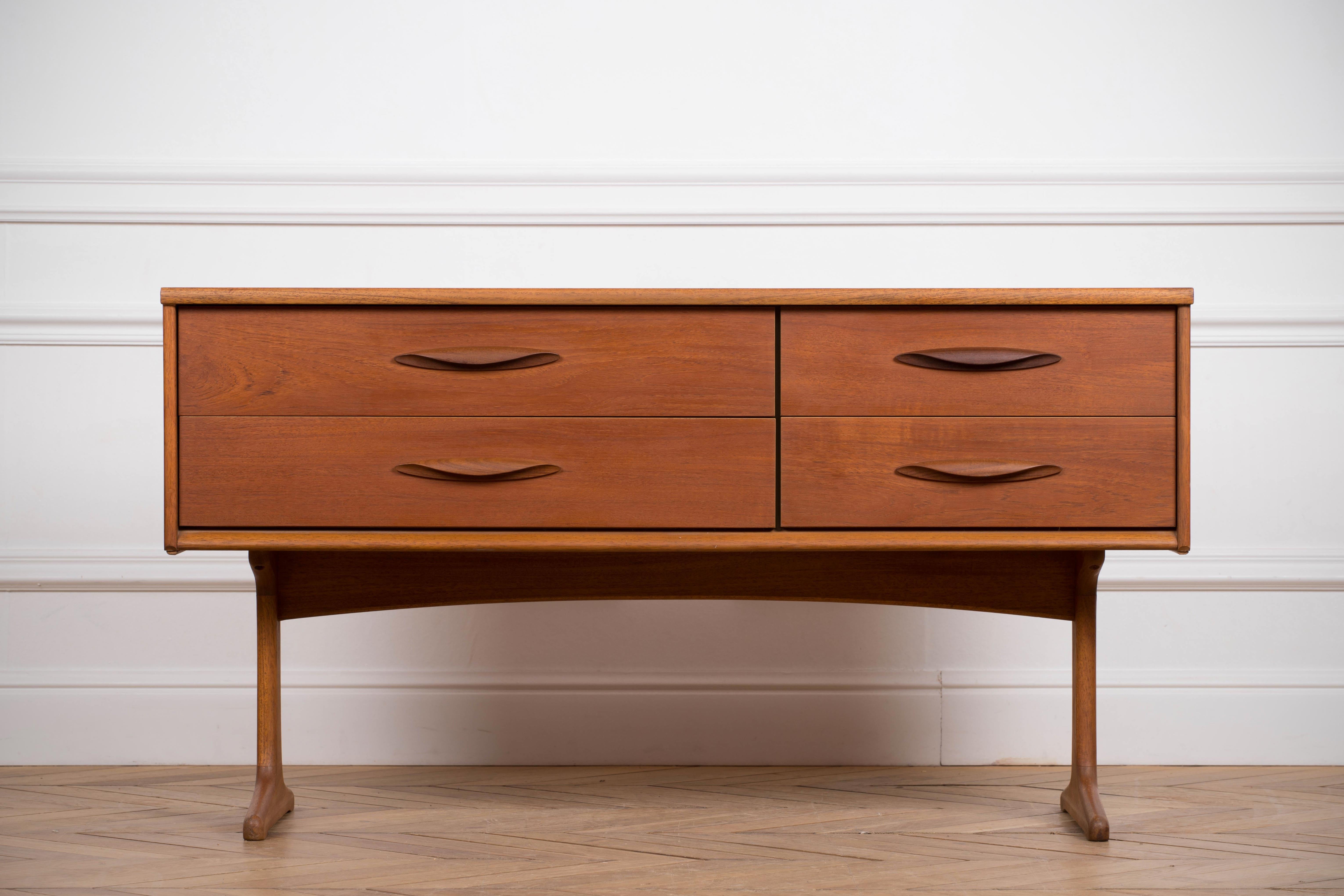 Design sideboard with clean lines and simple forms. Frank Guille designed this sideboard in the 1960s for Austinsuite. This high end teak wooden credenza has a lot of storage space.