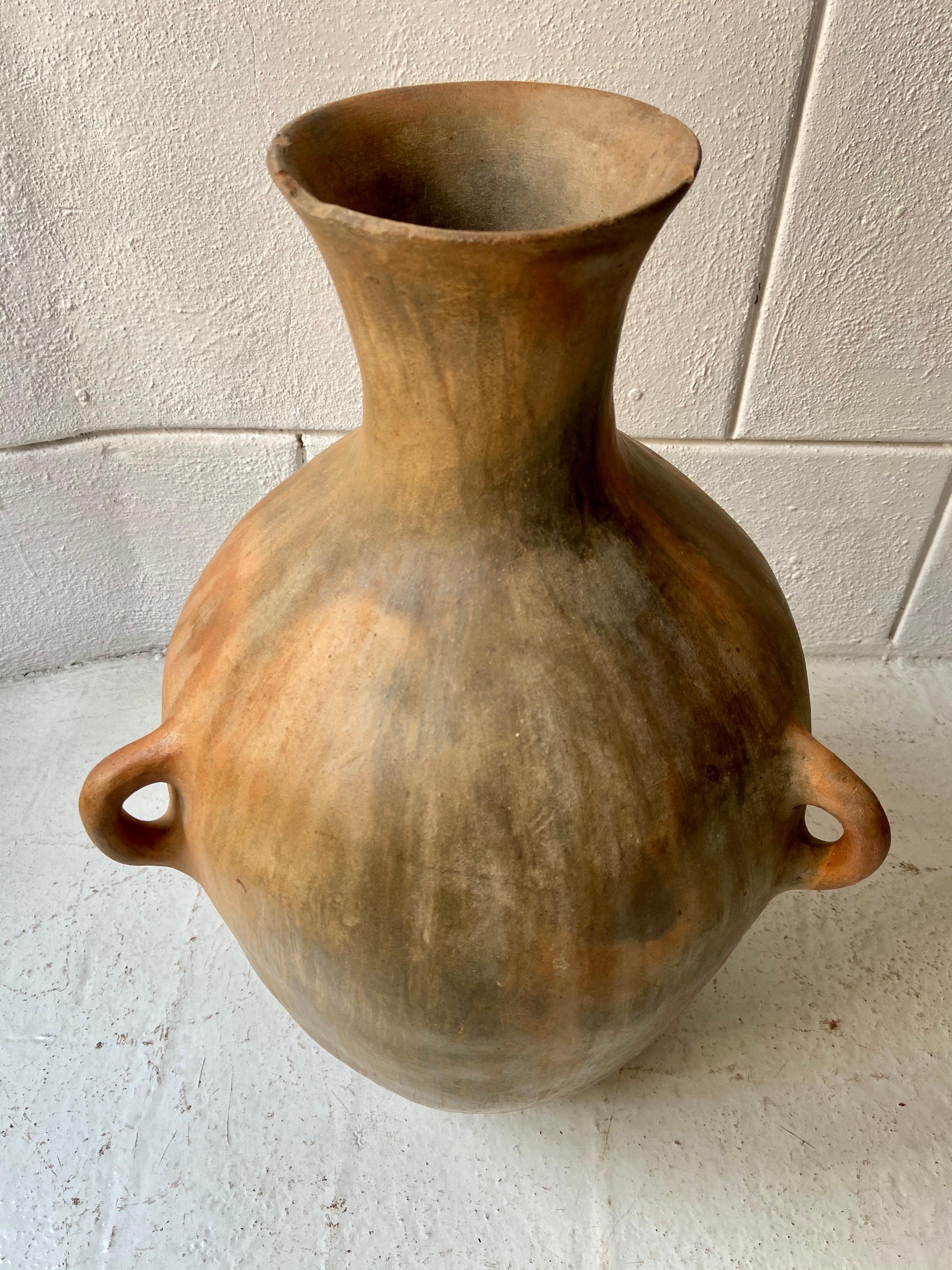 Ceramic water pot from the Northern Mountains of Puebla, circa 1960s. Vessel has 3 small handles (all intact) used for rope ties for transport purposes. This type of clay in particular tends to keep the water cool.