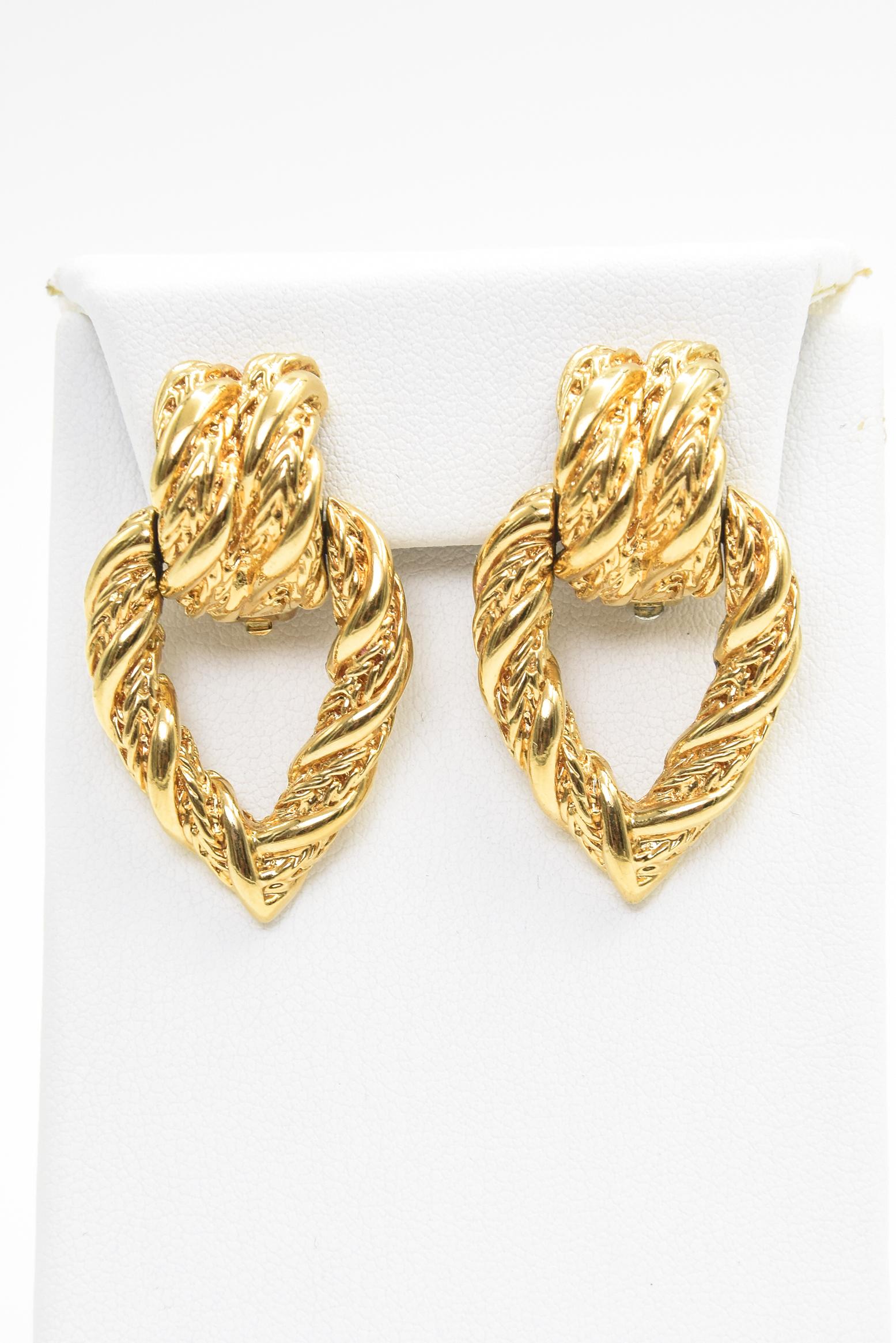 Vintage nicely made between the 1960-1970s gold toned textures clip on earrings contains a double bridge design from which an open tear drop hangs,  No post so easy to wear for everyone.
