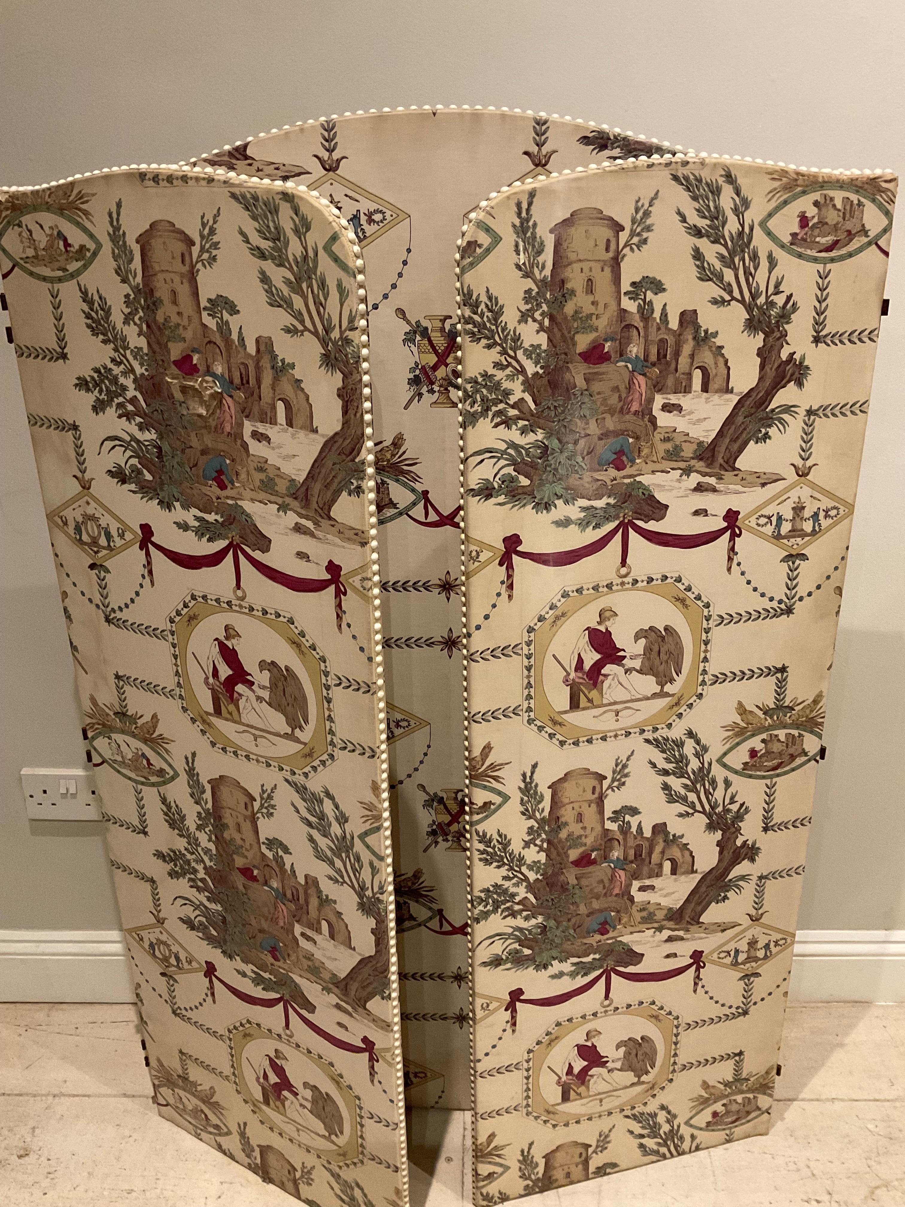 This circa 1940s/1950s French threefold screen is highly decorative versatile piece with two shorter panels sitting aside a wider fixed one.

The screen has fabric on both sides with off white studded edges and can easily free stand. It would also